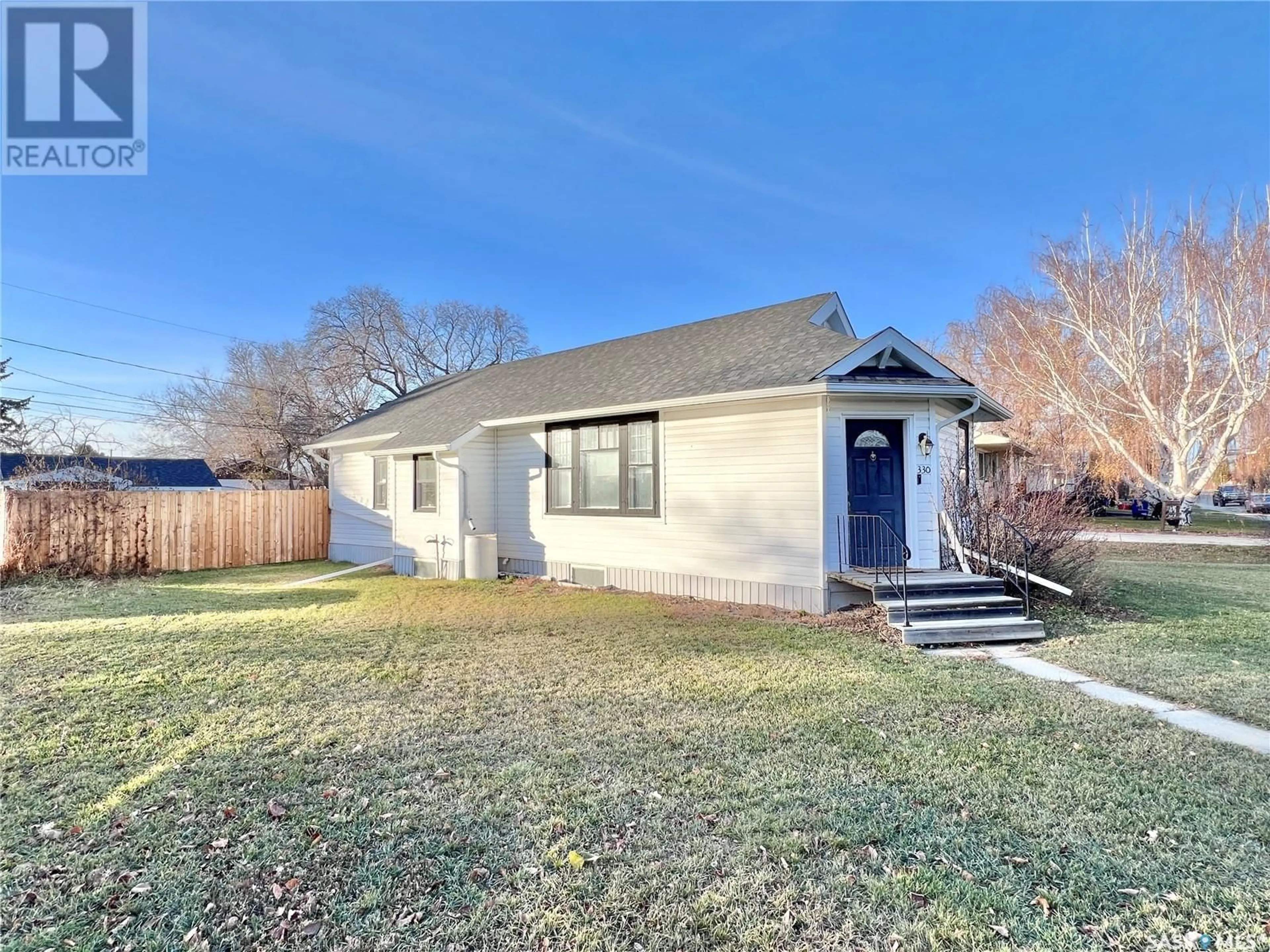 Frontside or backside of a home, the fenced backyard for 330 Thomson STREET, Outlook Saskatchewan S0L2N0