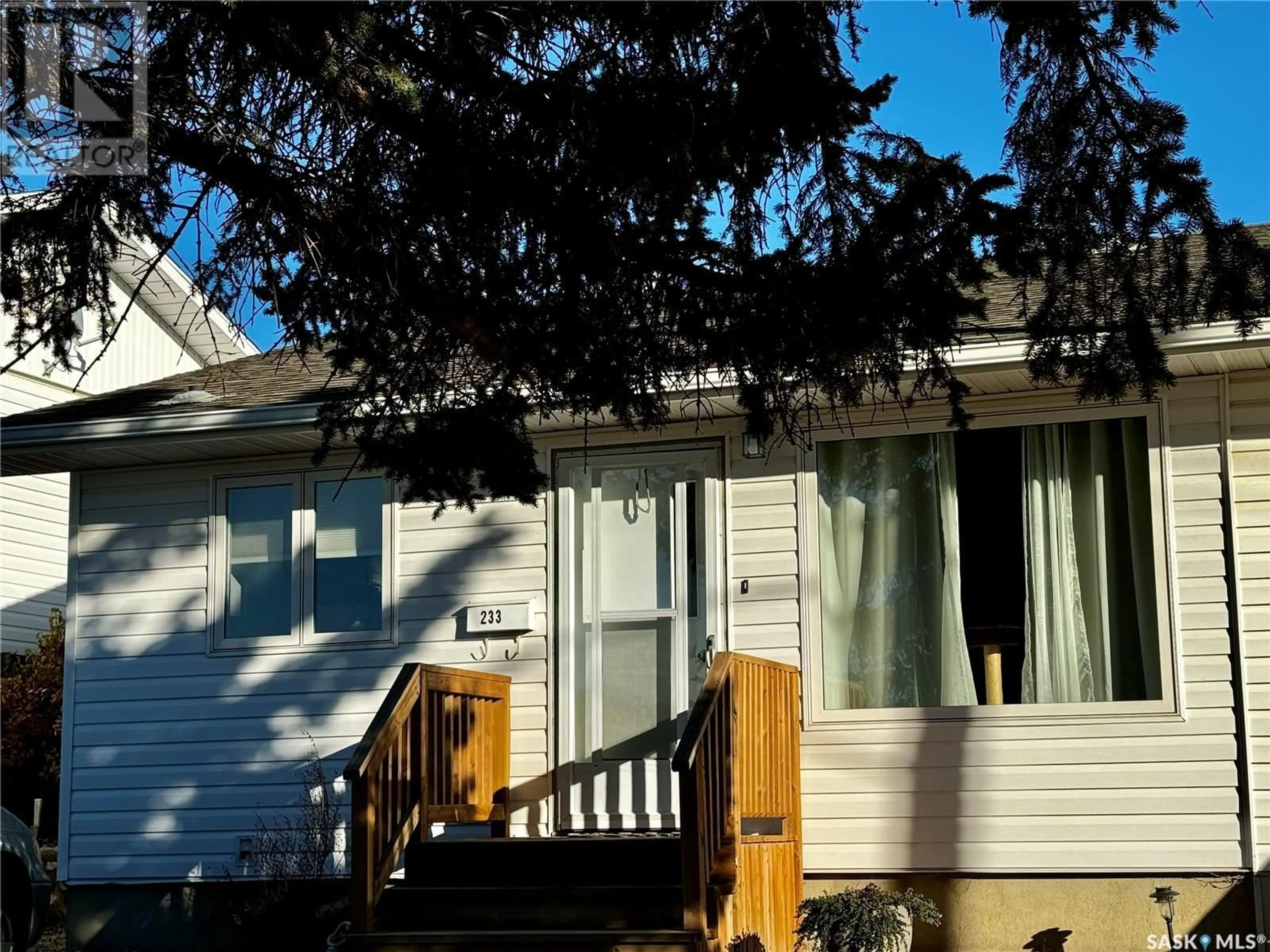 Home with vinyl exterior material, street for 233 18TH AVENUE, Swift Current Saskatchewan S9H2Y2
