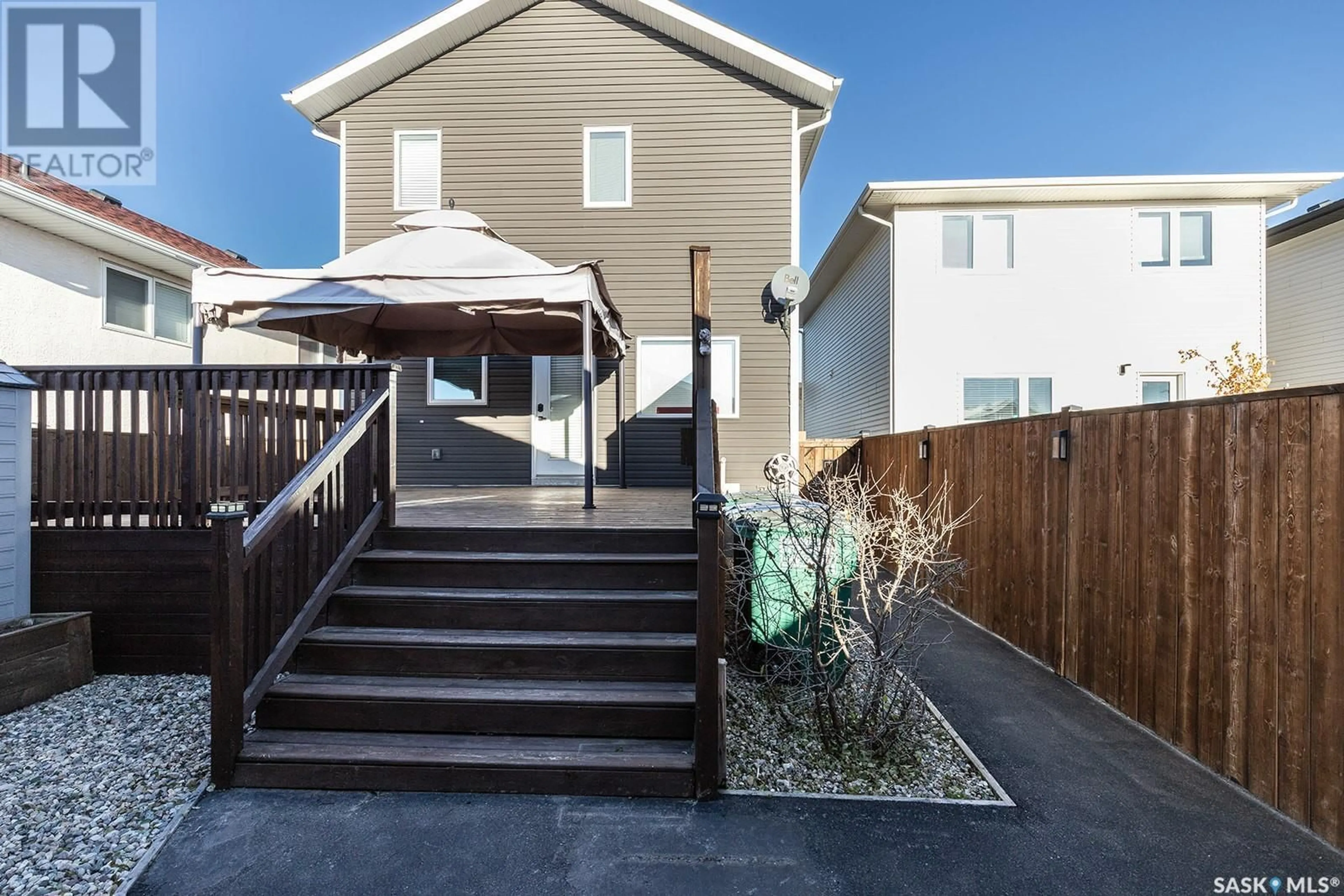 Frontside or backside of a home, the fenced backyard for 214 Bentley COURT, Saskatoon Saskatchewan S7L6L4