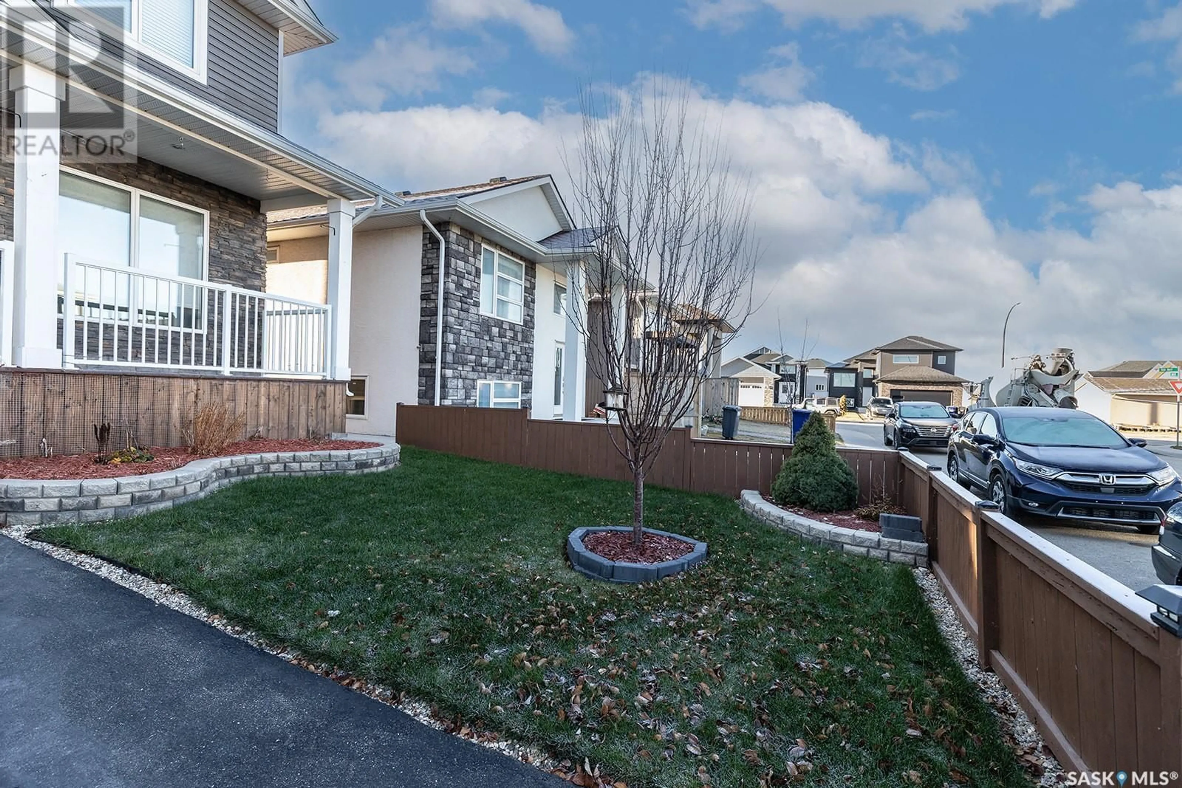 Frontside or backside of a home, the fenced backyard for 214 Bentley COURT, Saskatoon Saskatchewan S7L6L4