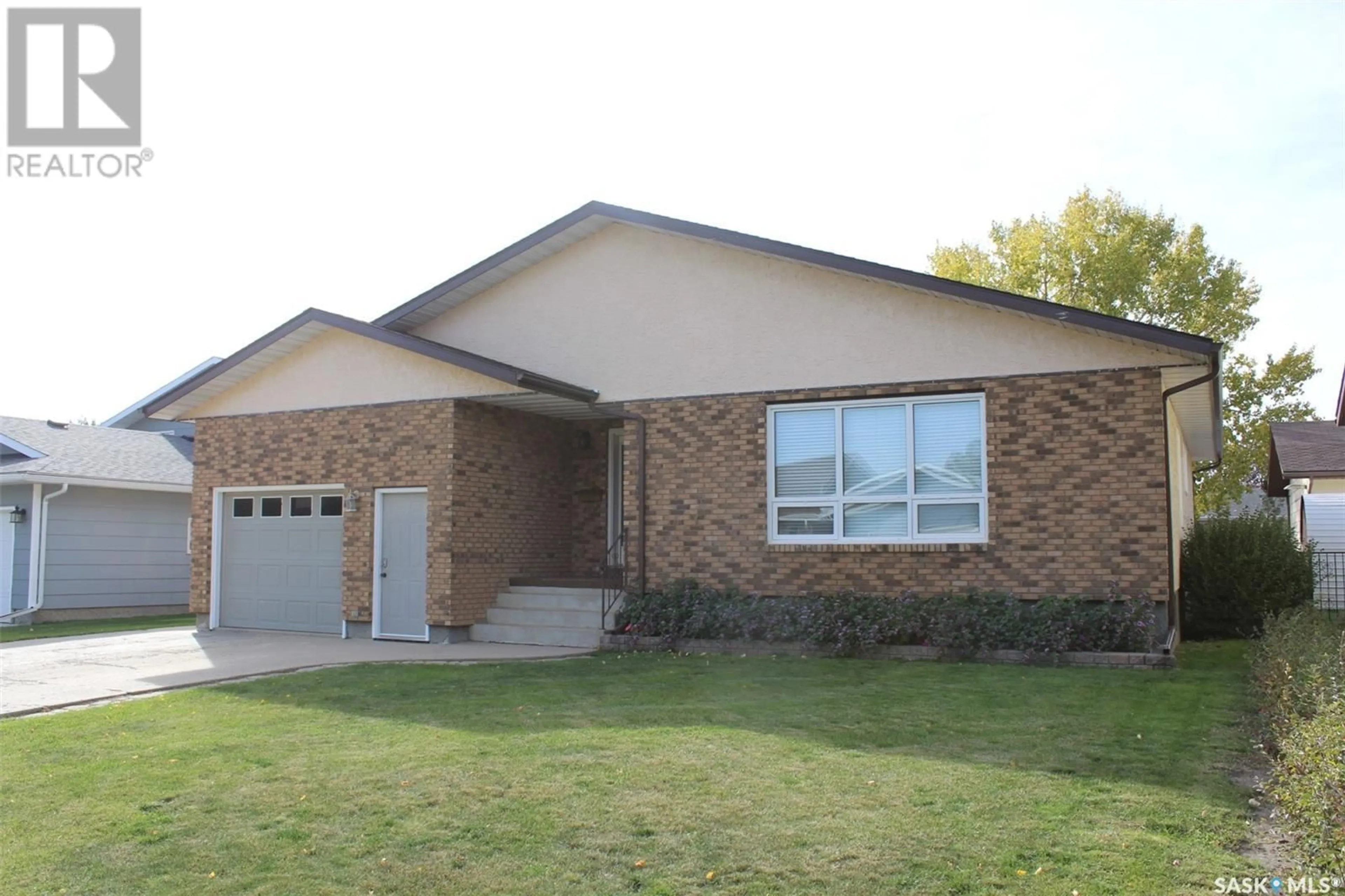 Home with brick exterior material for 723 Dieppe DRIVE, Weyburn Saskatchewan S4H3H4