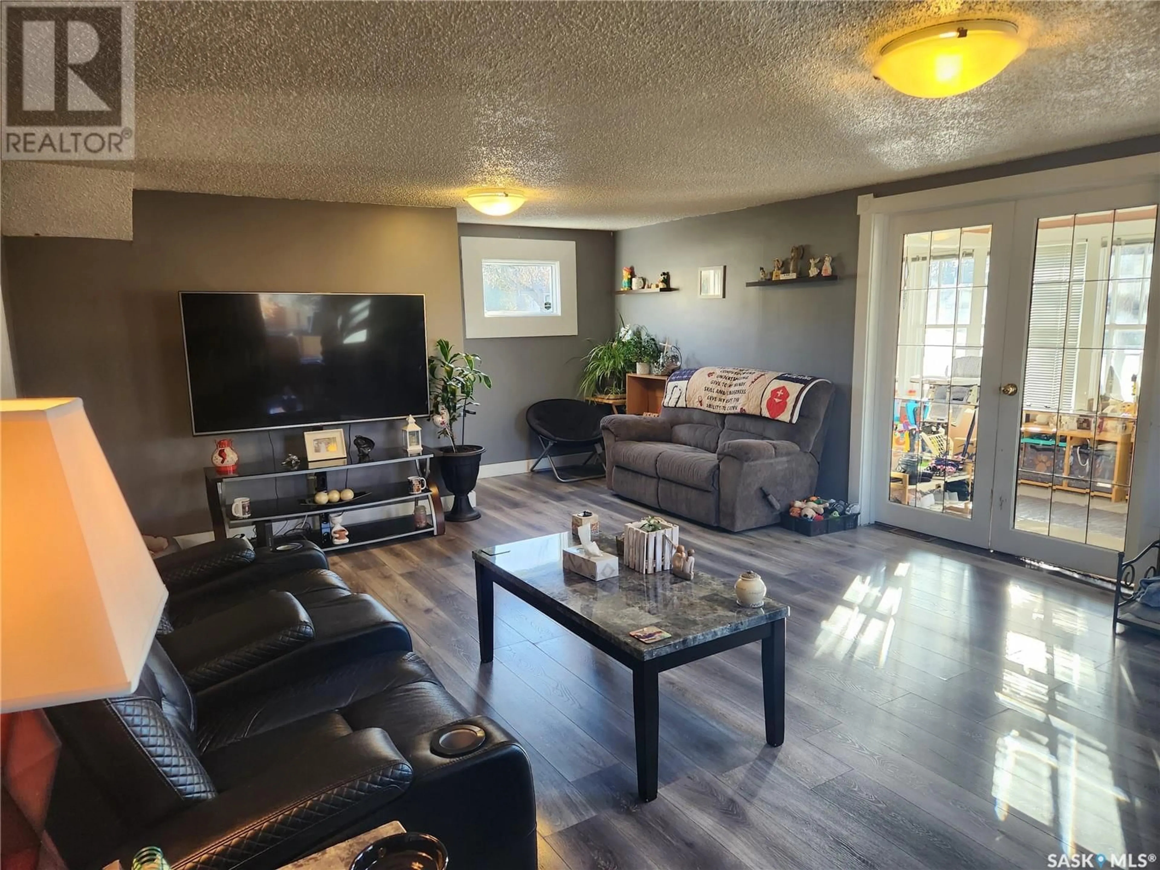 Living room with furniture, wood/laminate floor for 309 4TH STREET, Nipawin Saskatchewan S0E1E0