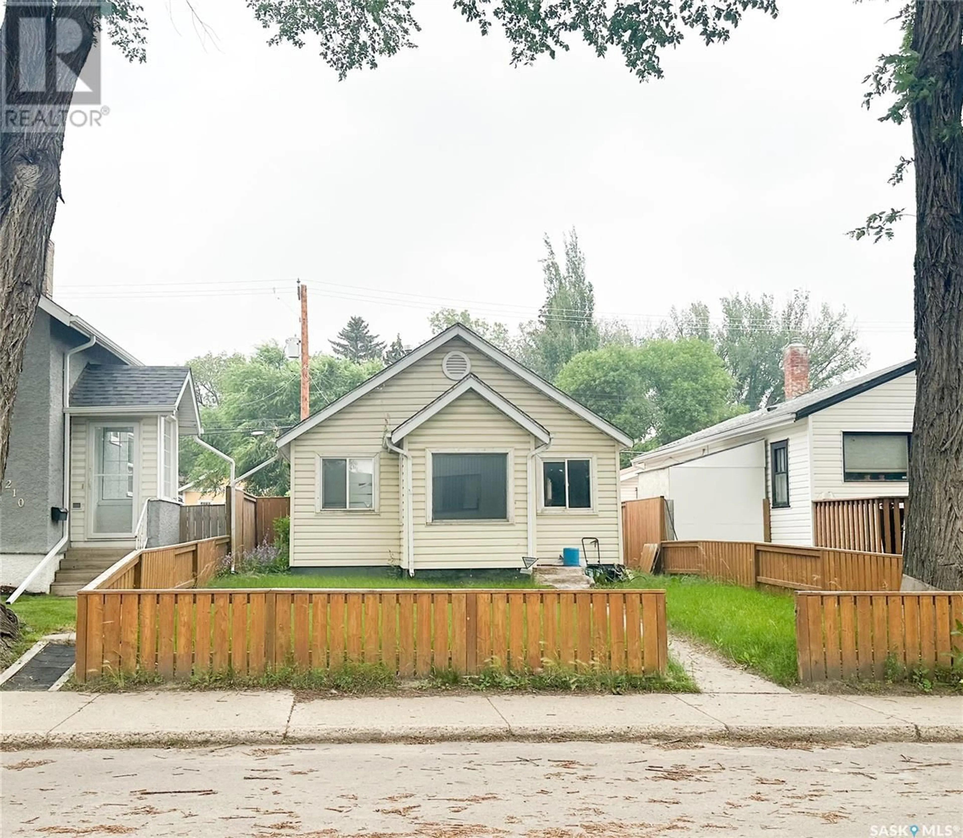 Frontside or backside of a home, the fenced backyard for 208 25th STREET W, Saskatoon Saskatchewan S7L0C4