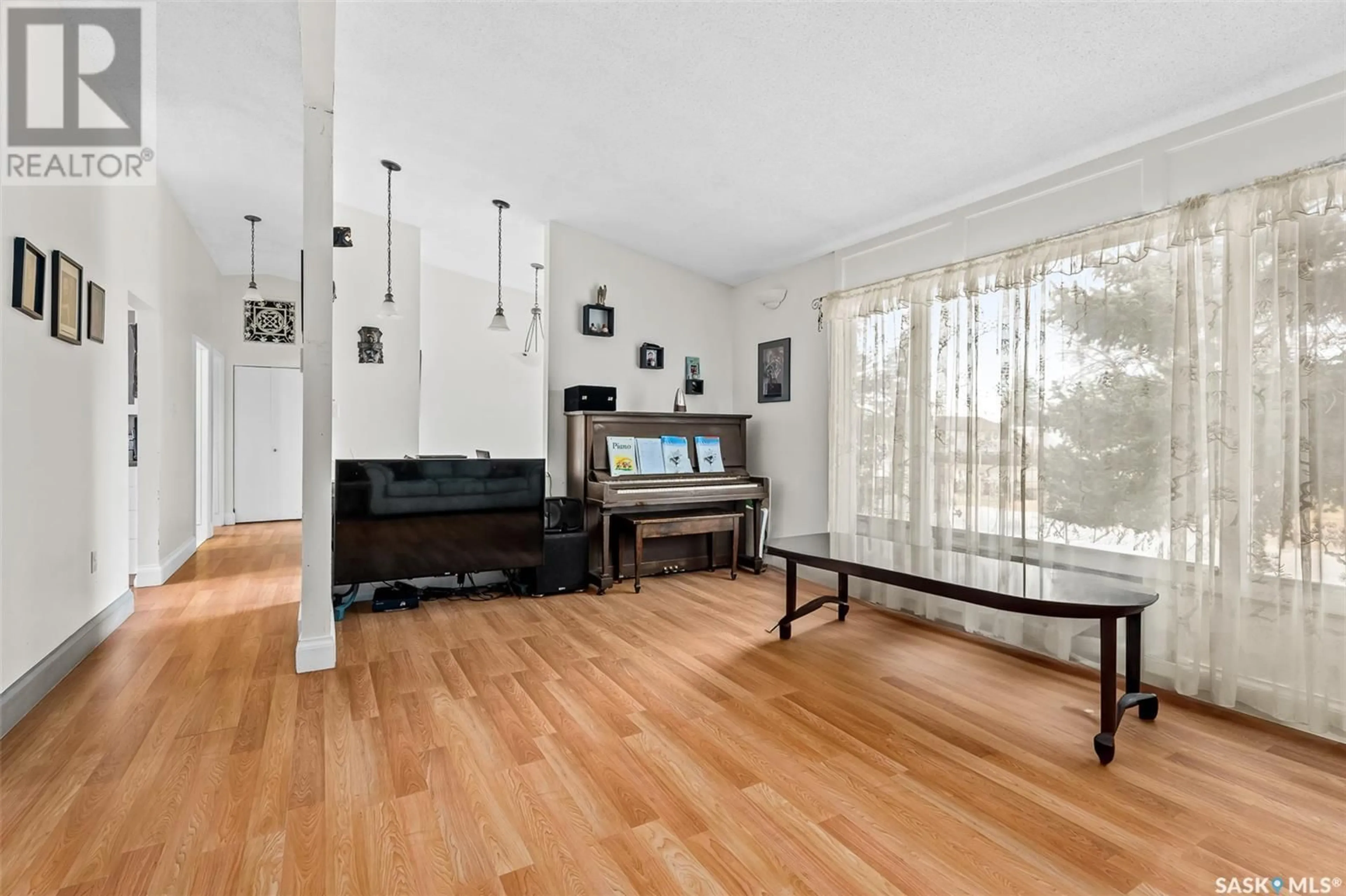 Living room with furniture, wood/laminate floor for 315 BIRCH STREET, Caronport Saskatchewan S0H0S0