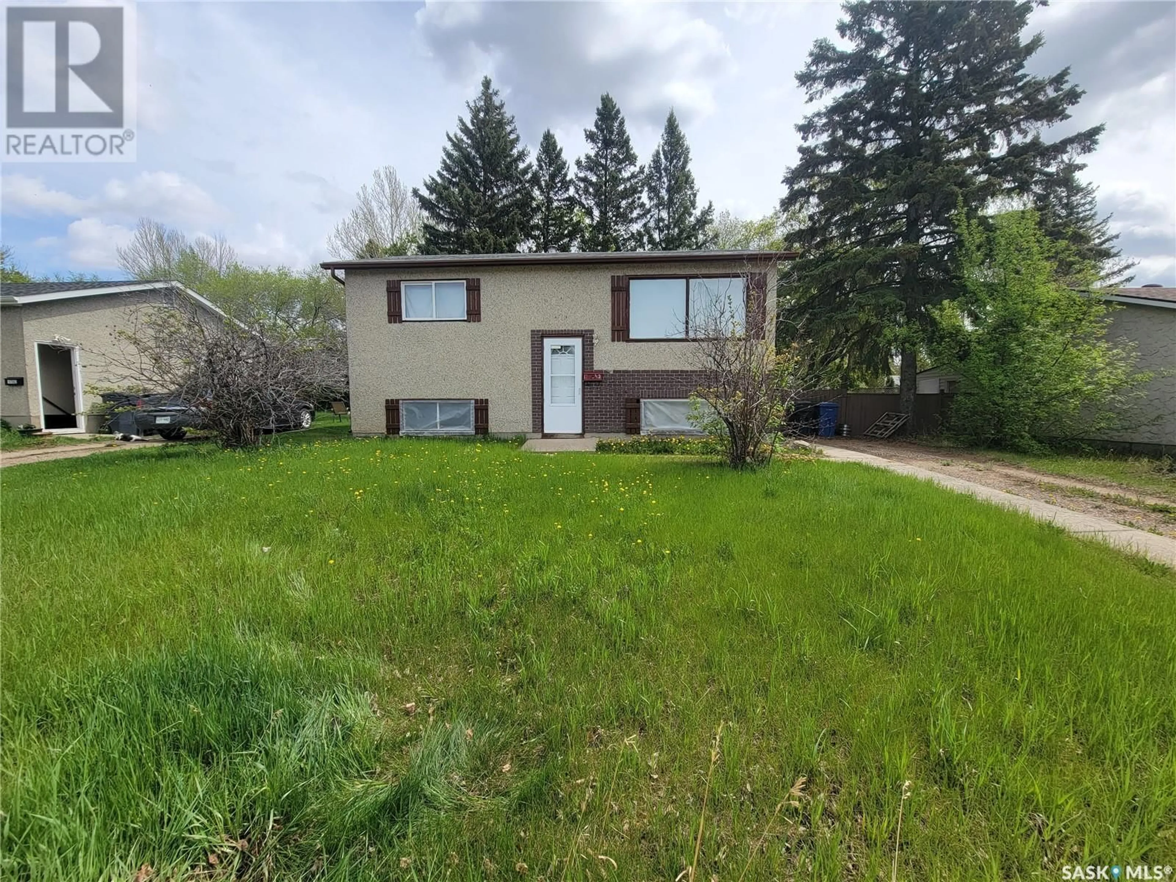 Frontside or backside of a home, the fenced backyard for 1742 Trudeau STREET, North Battleford Saskatchewan S9A3B8