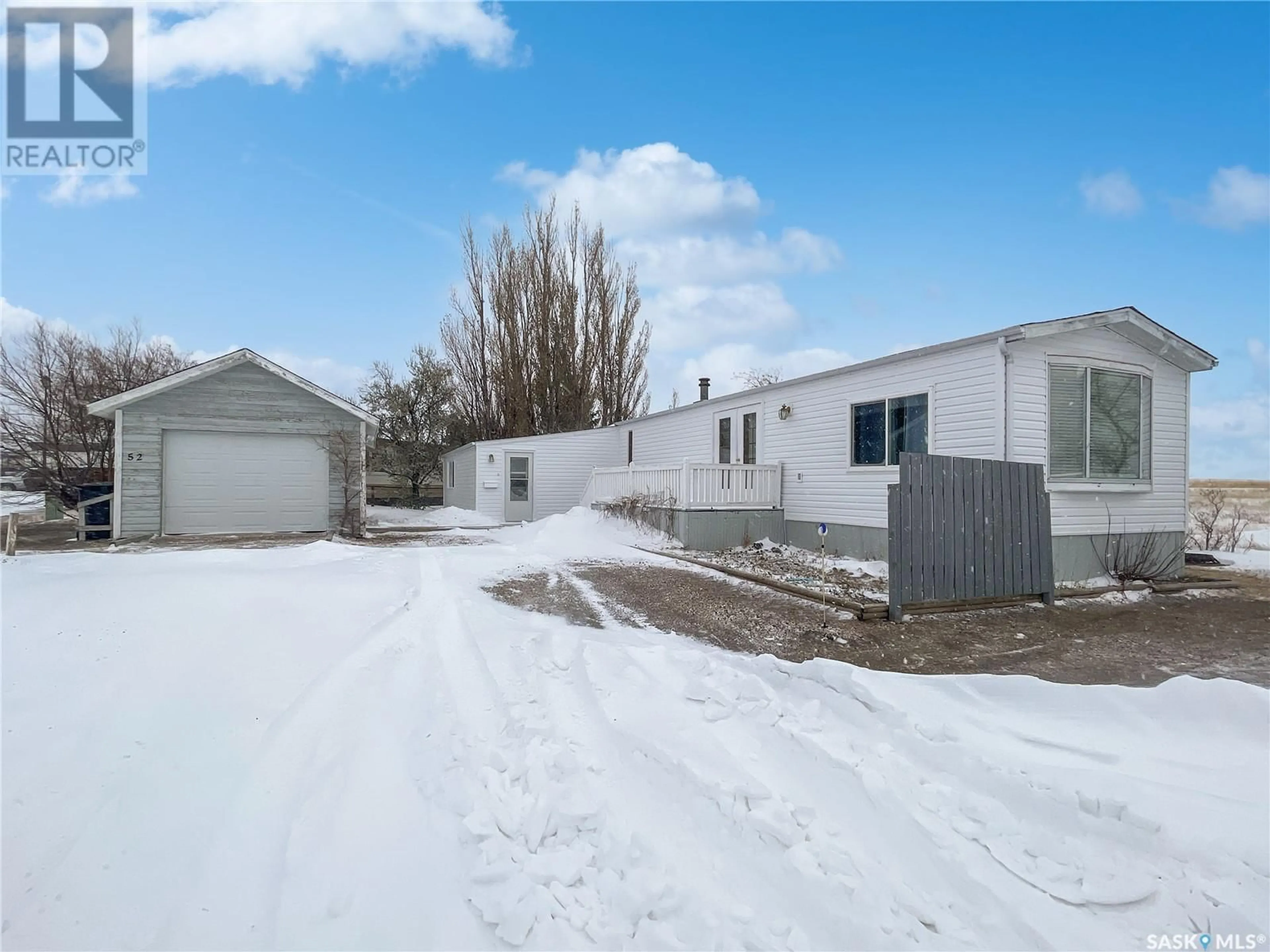 Frontside or backside of a home, the fenced backyard for 52 701 11th AVENUE NW, Swift Current Saskatchewan S9H4M5