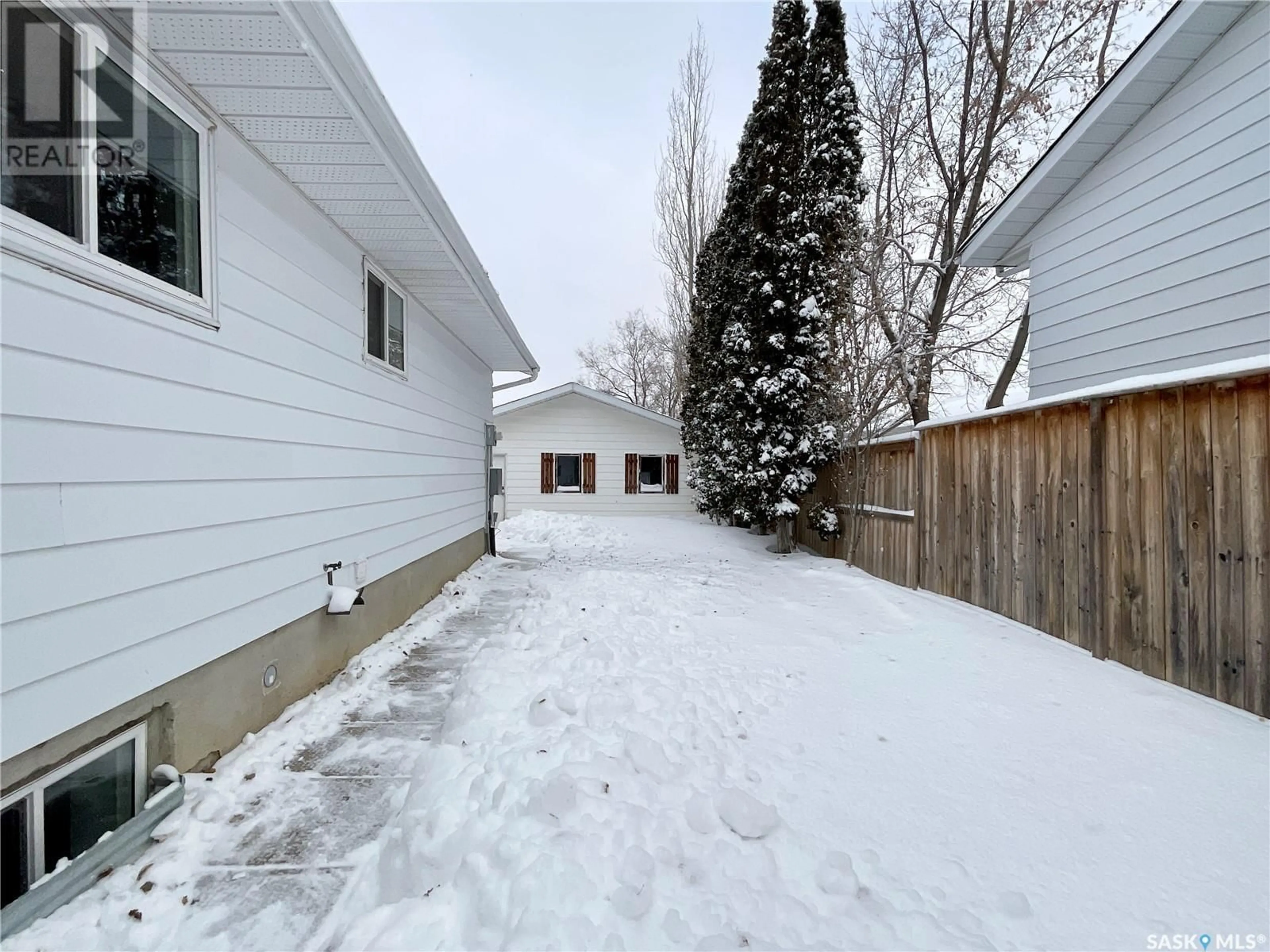 Frontside or backside of a home, the fenced backyard for 6814 1st AVENUE N, Regina Saskatchewan S4X1H9