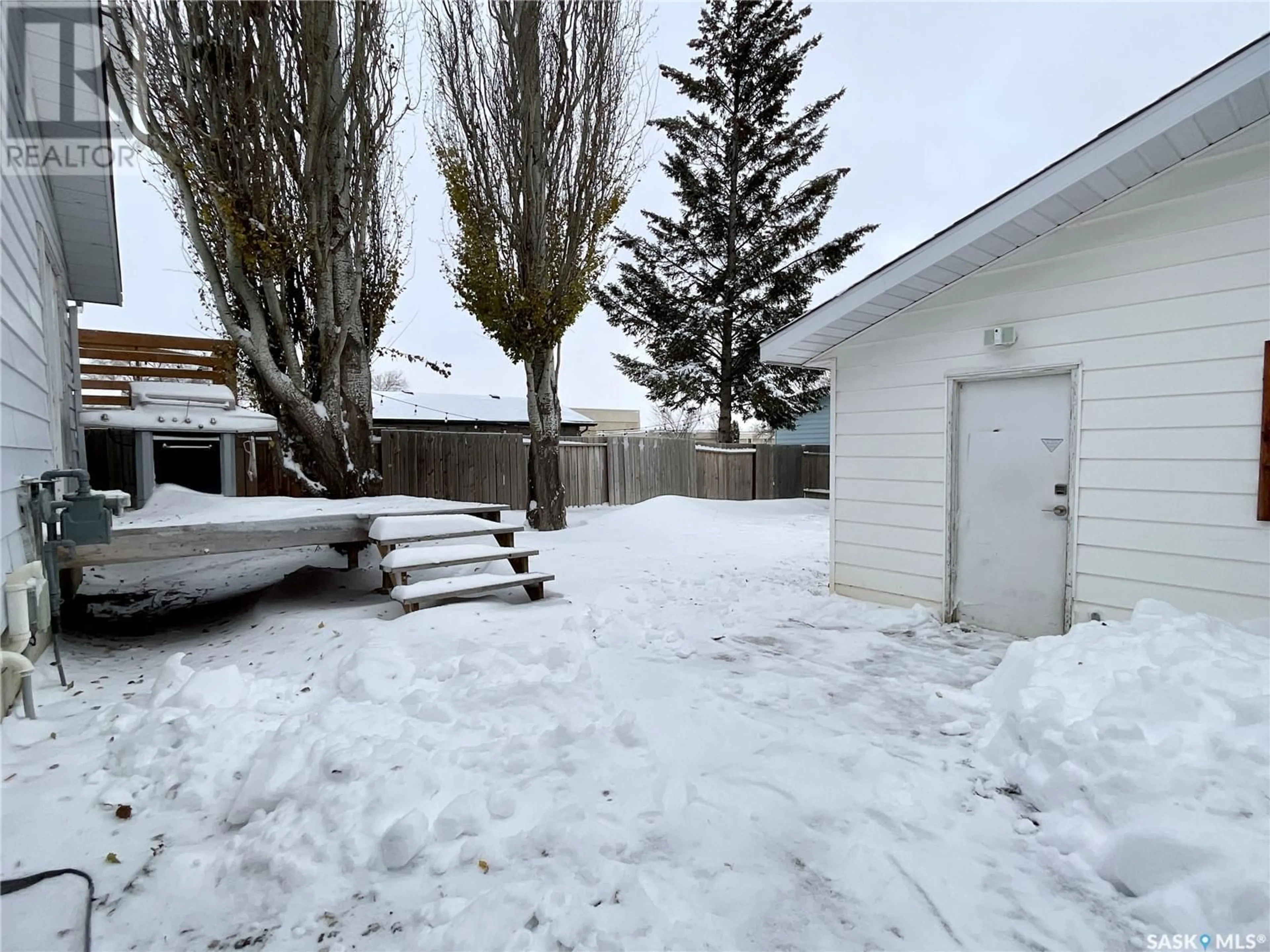 A pic from exterior of the house or condo, the fenced backyard for 6814 1st AVENUE N, Regina Saskatchewan S4X1H9