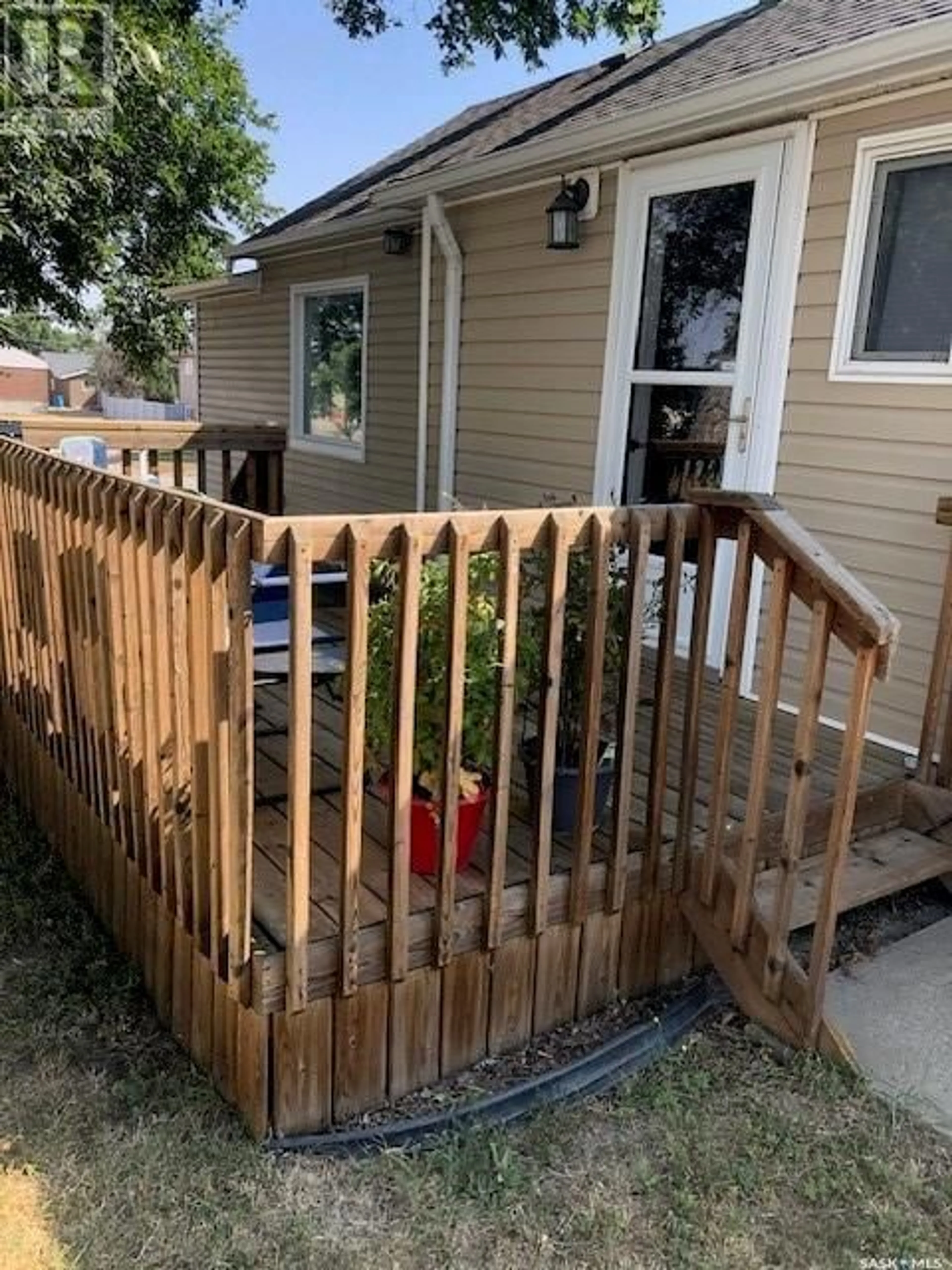 Frontside or backside of a home, the fenced backyard for 206 3rd AVENUE E, Assiniboia Saskatchewan S0H0B0