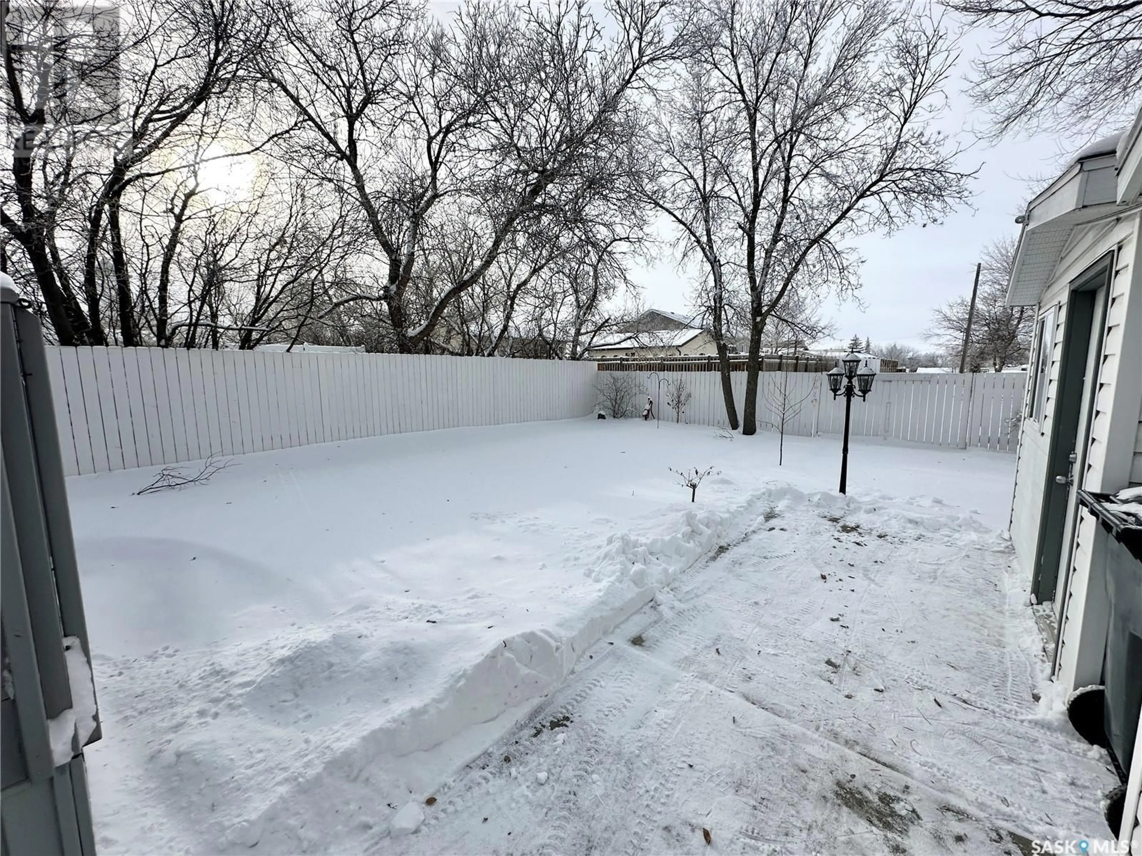 A pic from exterior of the house or condo, the fenced backyard for 811 4th STREET S, Weyburn Saskatchewan S4H2G4