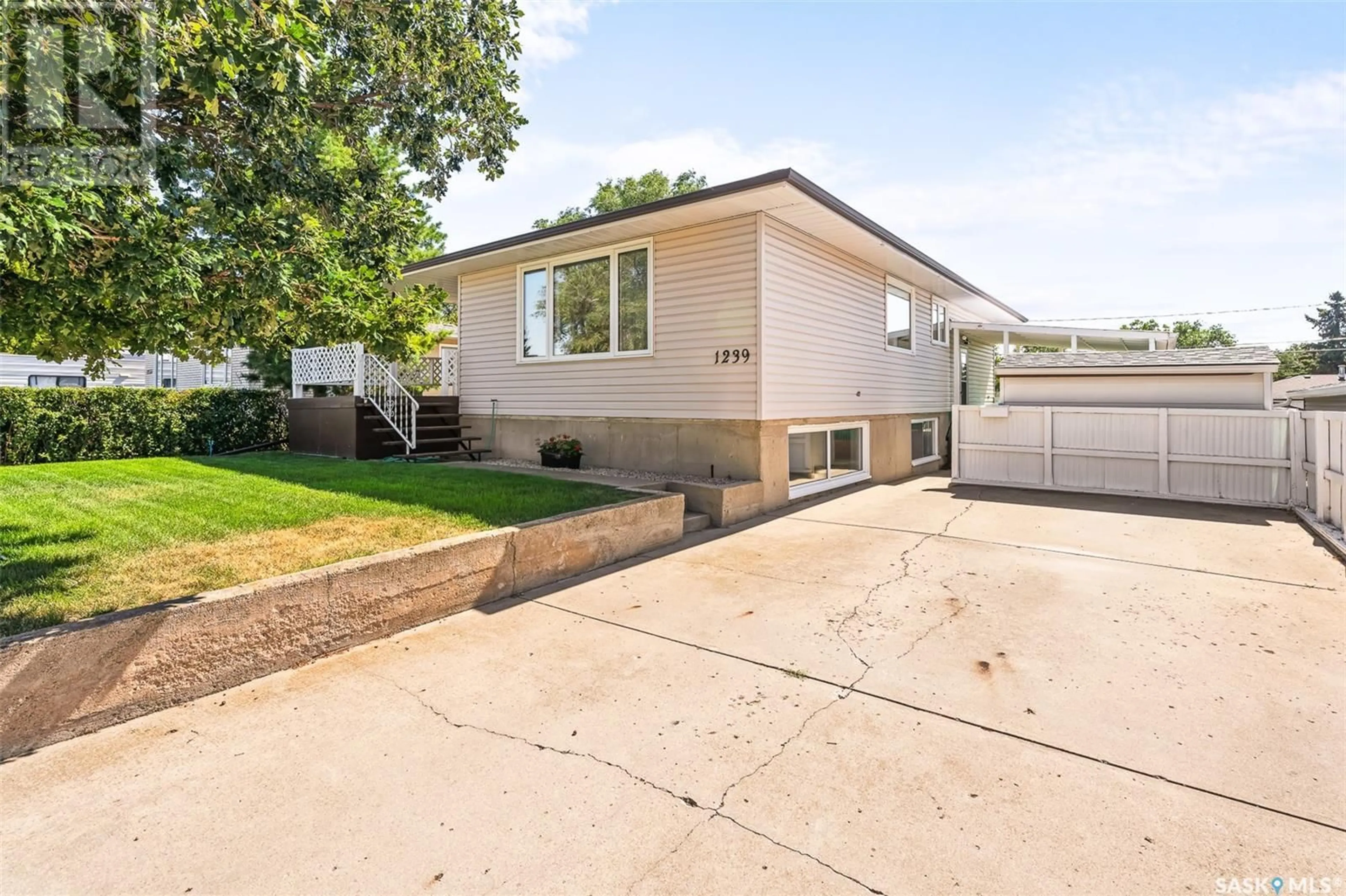 Frontside or backside of a home, the fenced backyard for 1239 Hochelaga STREET W, Moose Jaw Saskatchewan S6H2J5