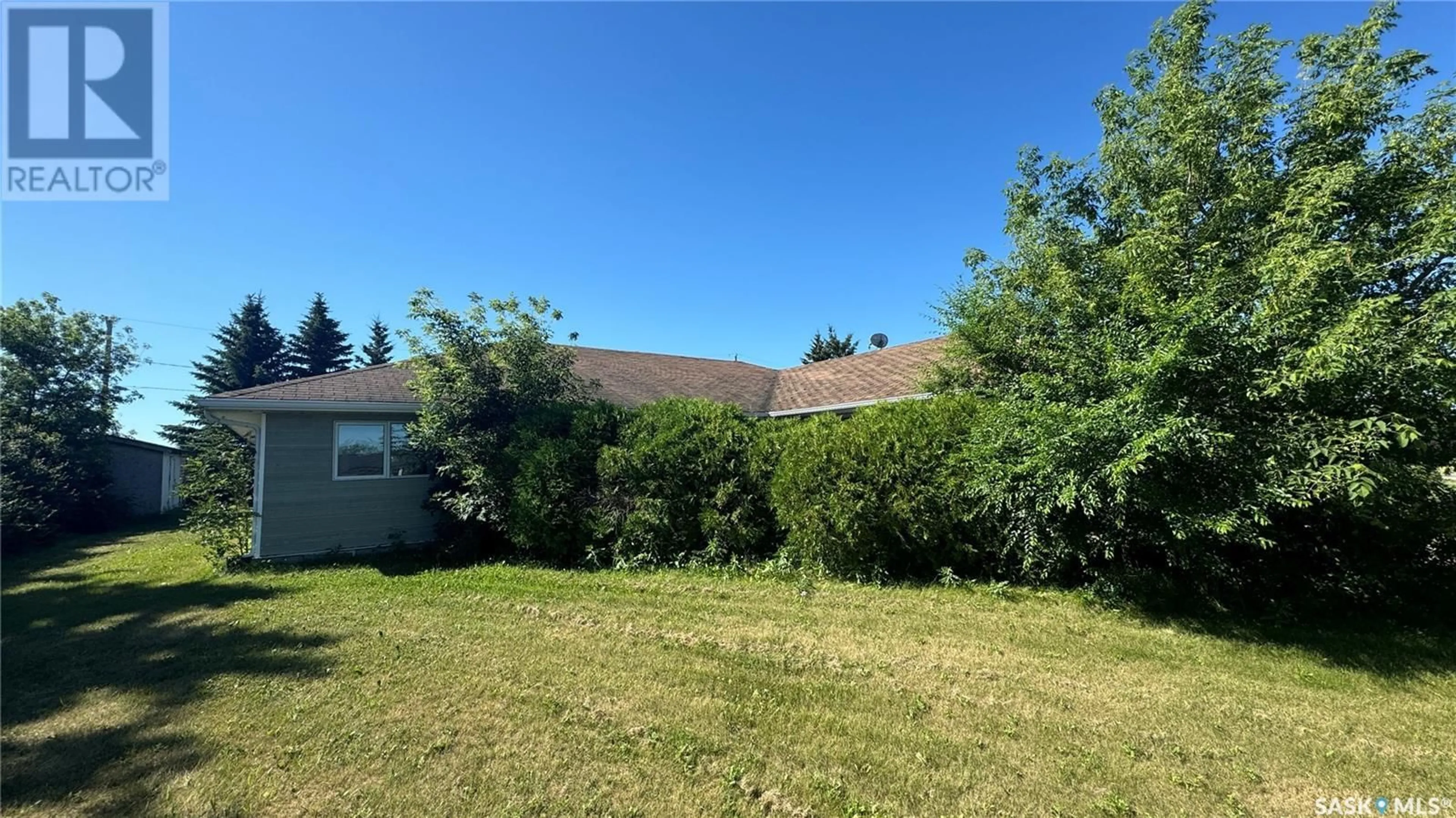 Frontside or backside of a home, the fenced backyard for 14 Poplar DRIVE, Birch Hills Saskatchewan S0J0G0