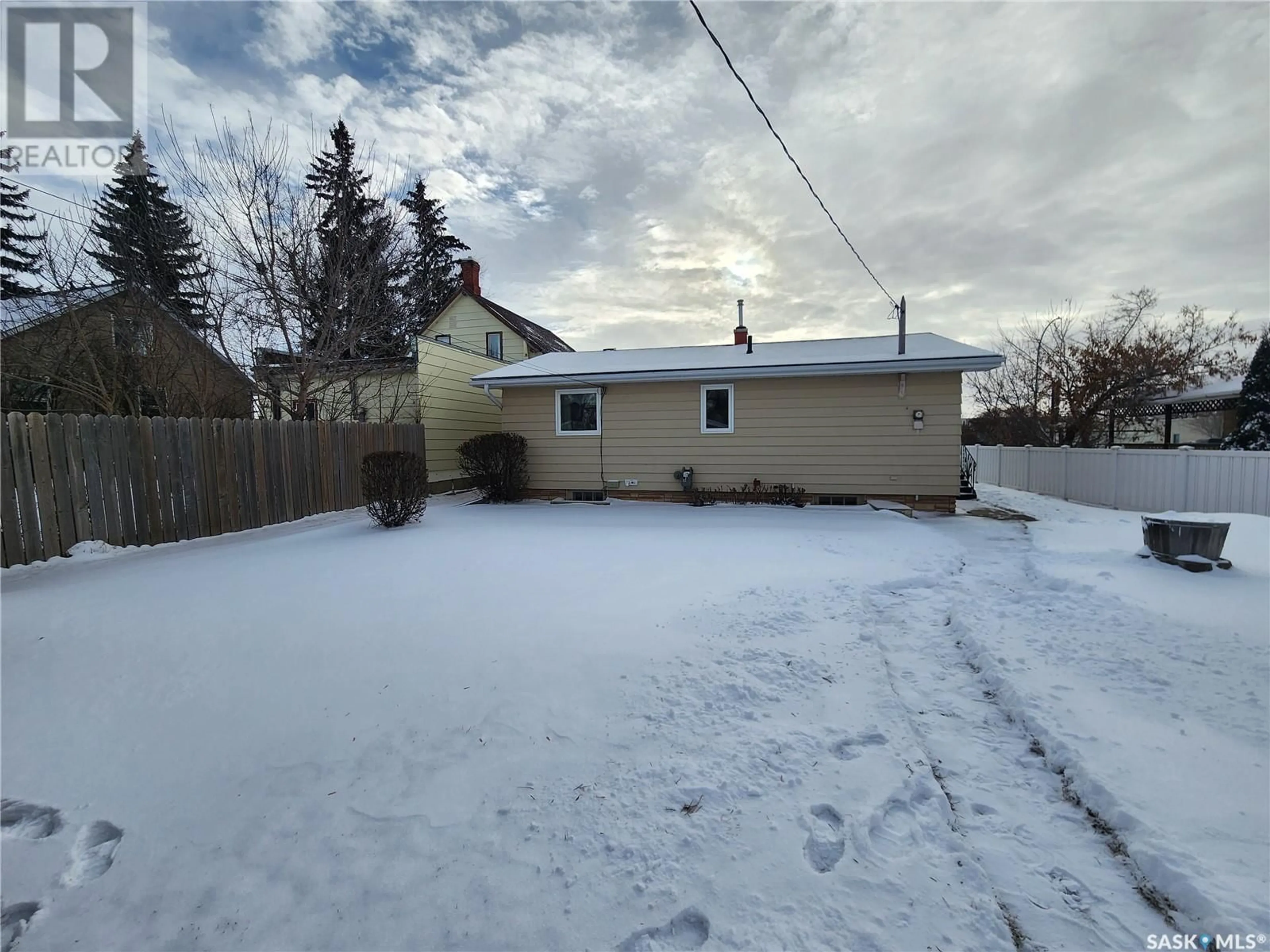 Frontside or backside of a home, the fenced backyard for 212 3rd AVENUE E, Melville Saskatchewan S0A2P0