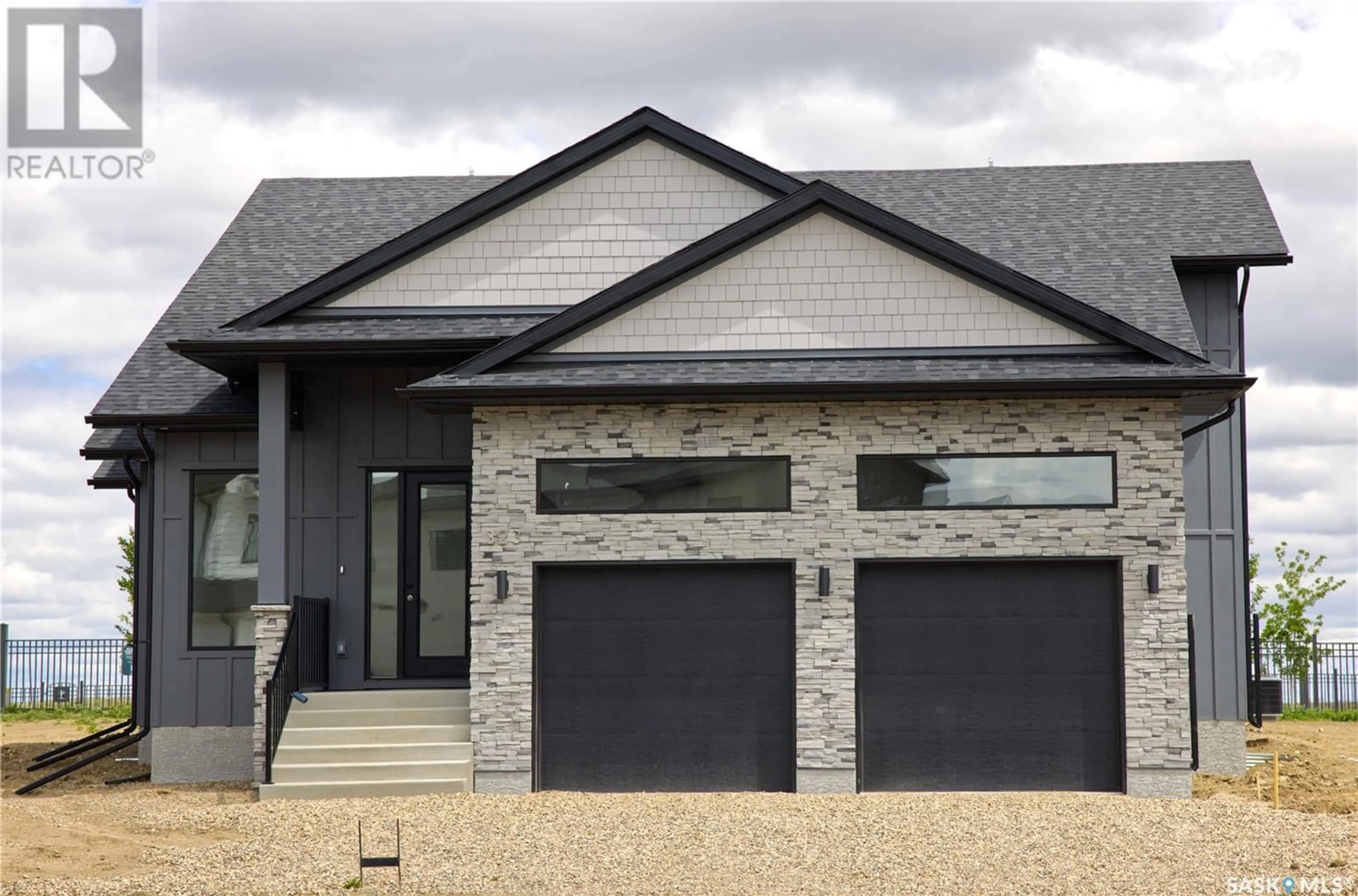 Home with brick exterior material for 323 Woolf BAY, Saskatoon Saskatchewan S7W1E5