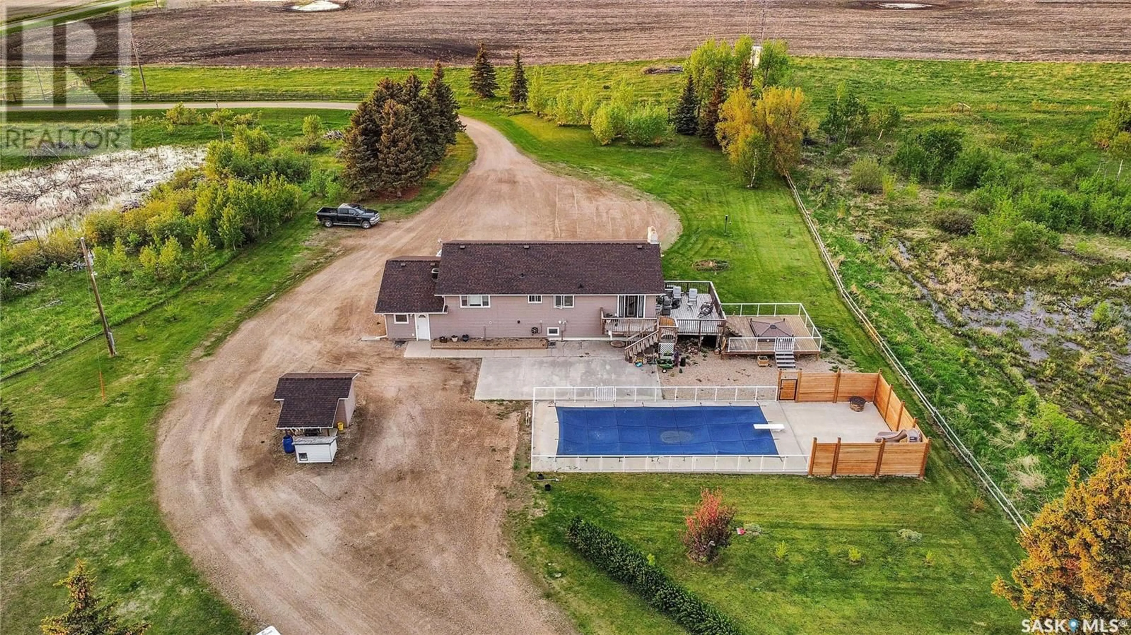 A pic from exterior of the house or condo, the fenced backyard for Moose Mtn View Acreage, Moose Mountain Rm No. 63 Saskatchewan S0C0R0