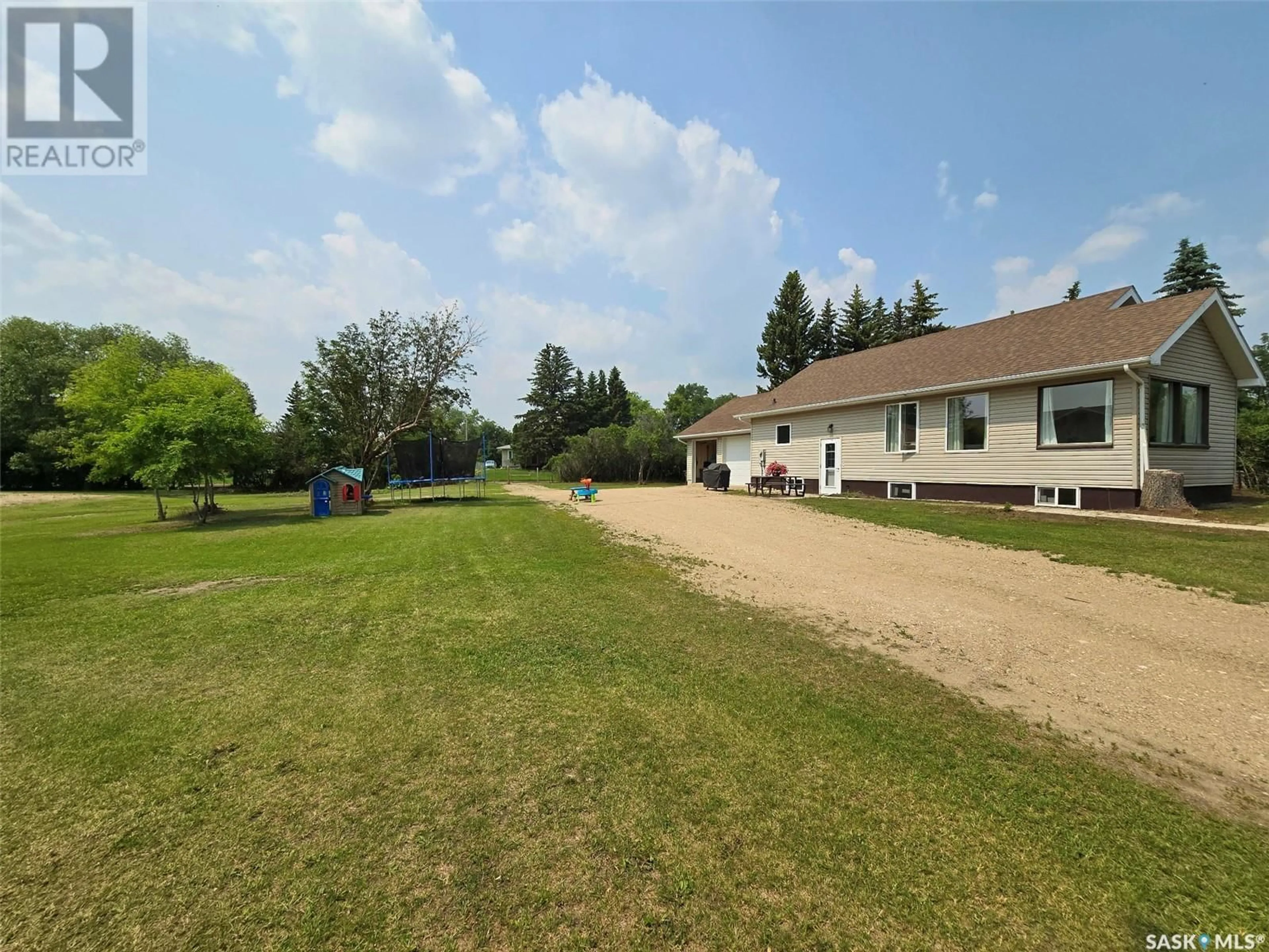 Frontside or backside of a home, the fenced backyard for 35 Mayo STREET, Lanigan Saskatchewan S0K2M0