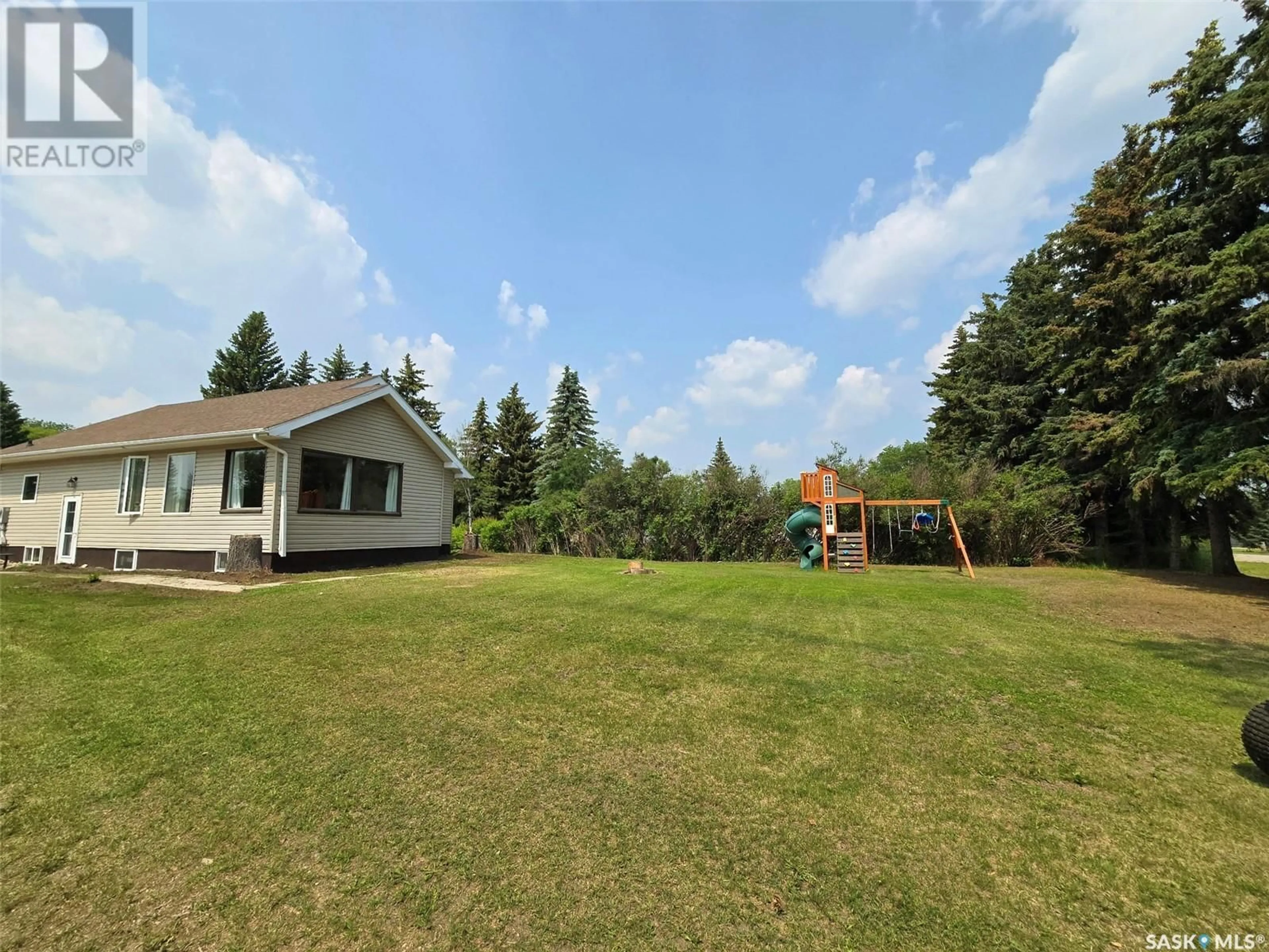 Frontside or backside of a home, the fenced backyard for 35 Mayo STREET, Lanigan Saskatchewan S0K2M0