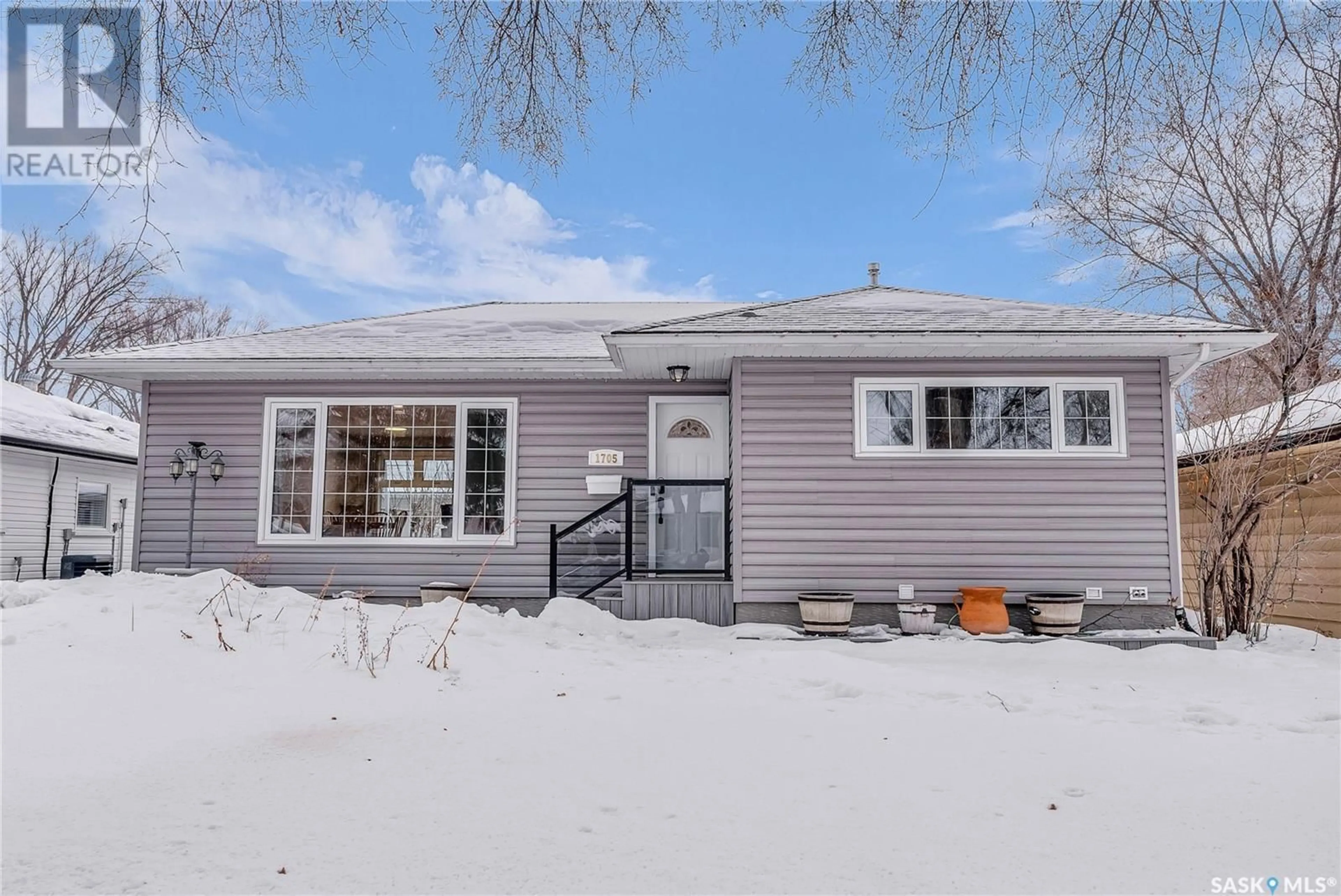 Home with vinyl exterior material, street for 1705 Louise AVENUE, Saskatoon Saskatchewan S7H2R5