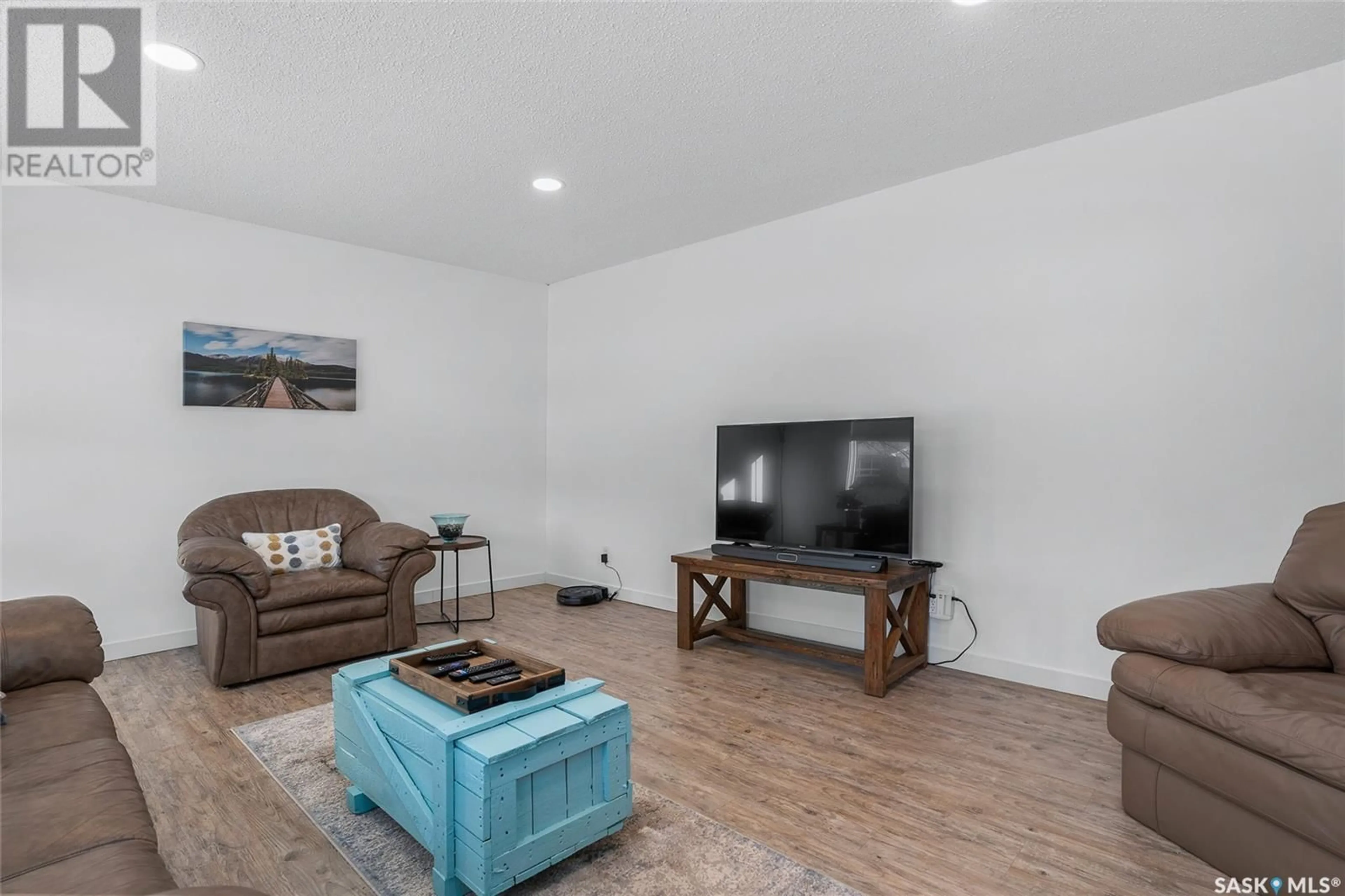 Living room with furniture, wood/laminate floor for 50 Richmond CRESCENT, Saskatoon Saskatchewan S7K1A8