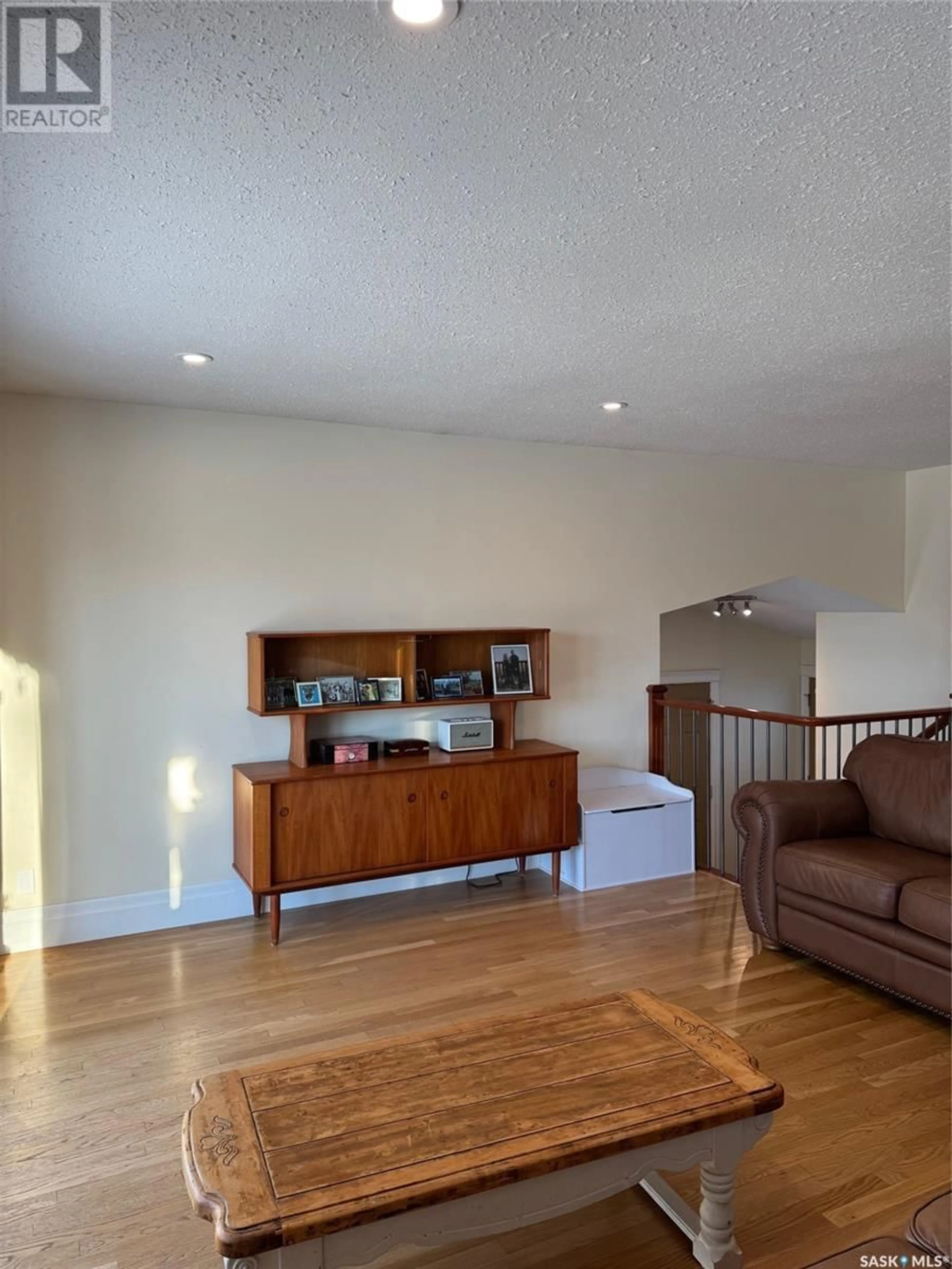 Living room with furniture, wood/laminate floor for 2506 Cardinal CRESCENT, North Battleford Saskatchewan S9A3X8