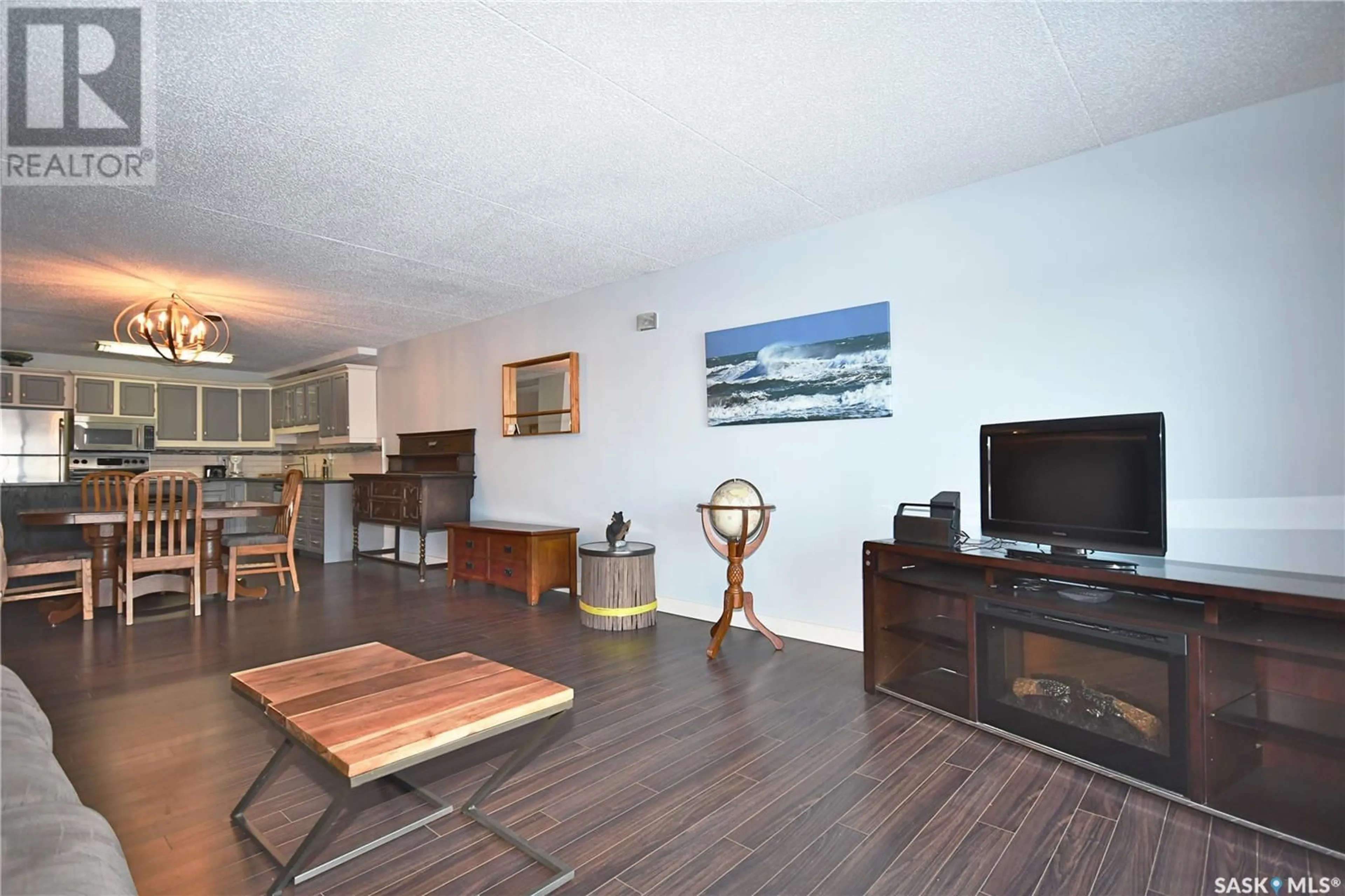 Living room with furniture, wood/laminate floor for 2C 516 River STREET E, Prince Albert Saskatchewan S6V0A6