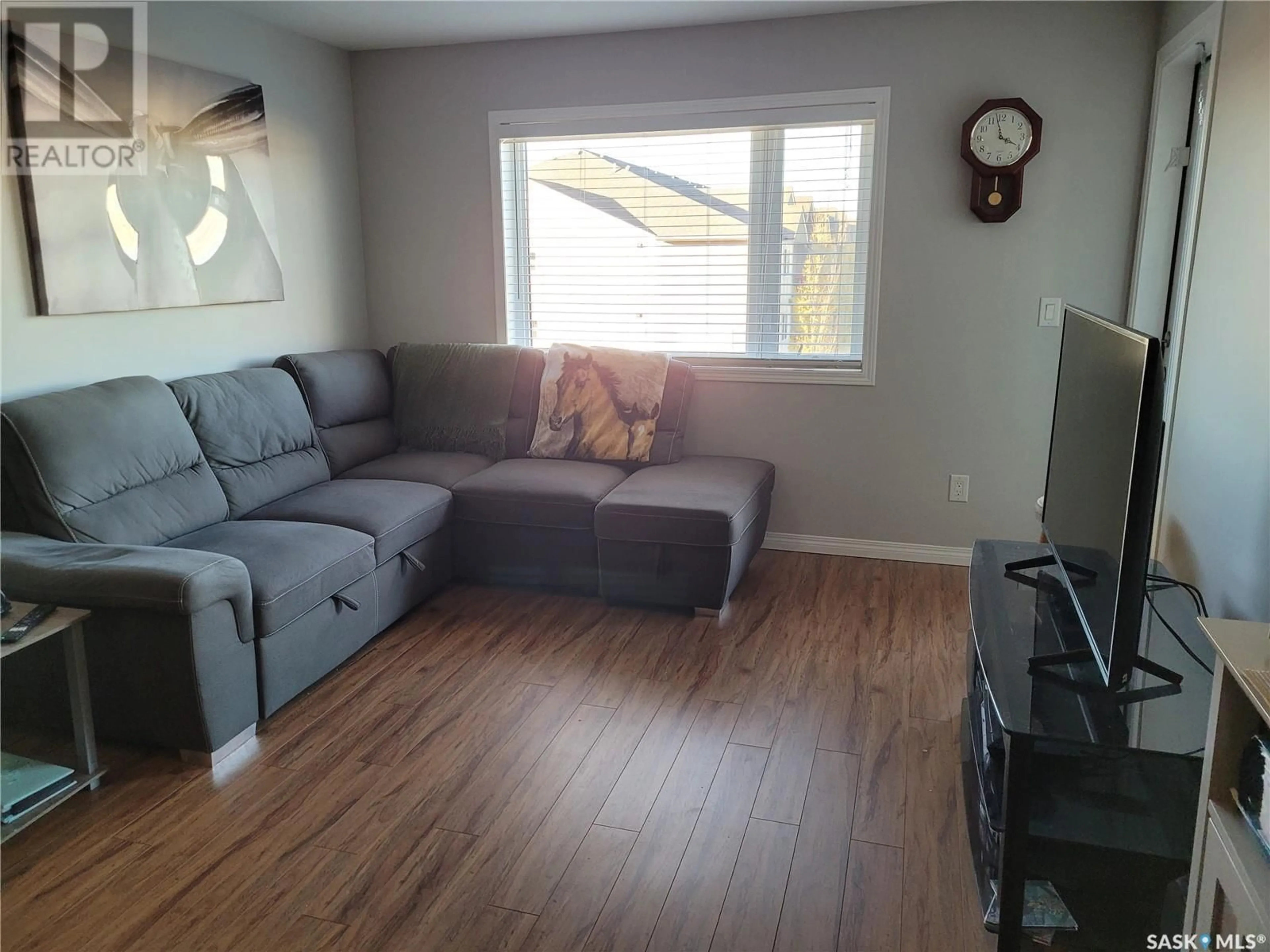 Living room with furniture, wood/laminate floor for 6303 112 Willis CRESCENT, Saskatoon Saskatchewan S7T0N3