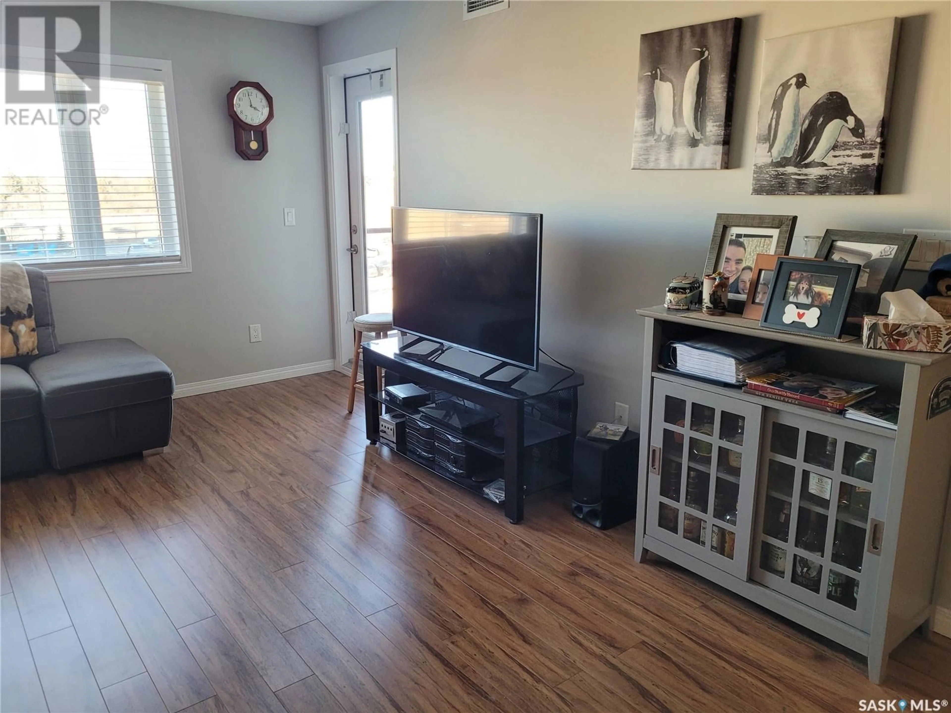 Living room with furniture, wood/laminate floor for 6303 112 Willis CRESCENT, Saskatoon Saskatchewan S7T0N3