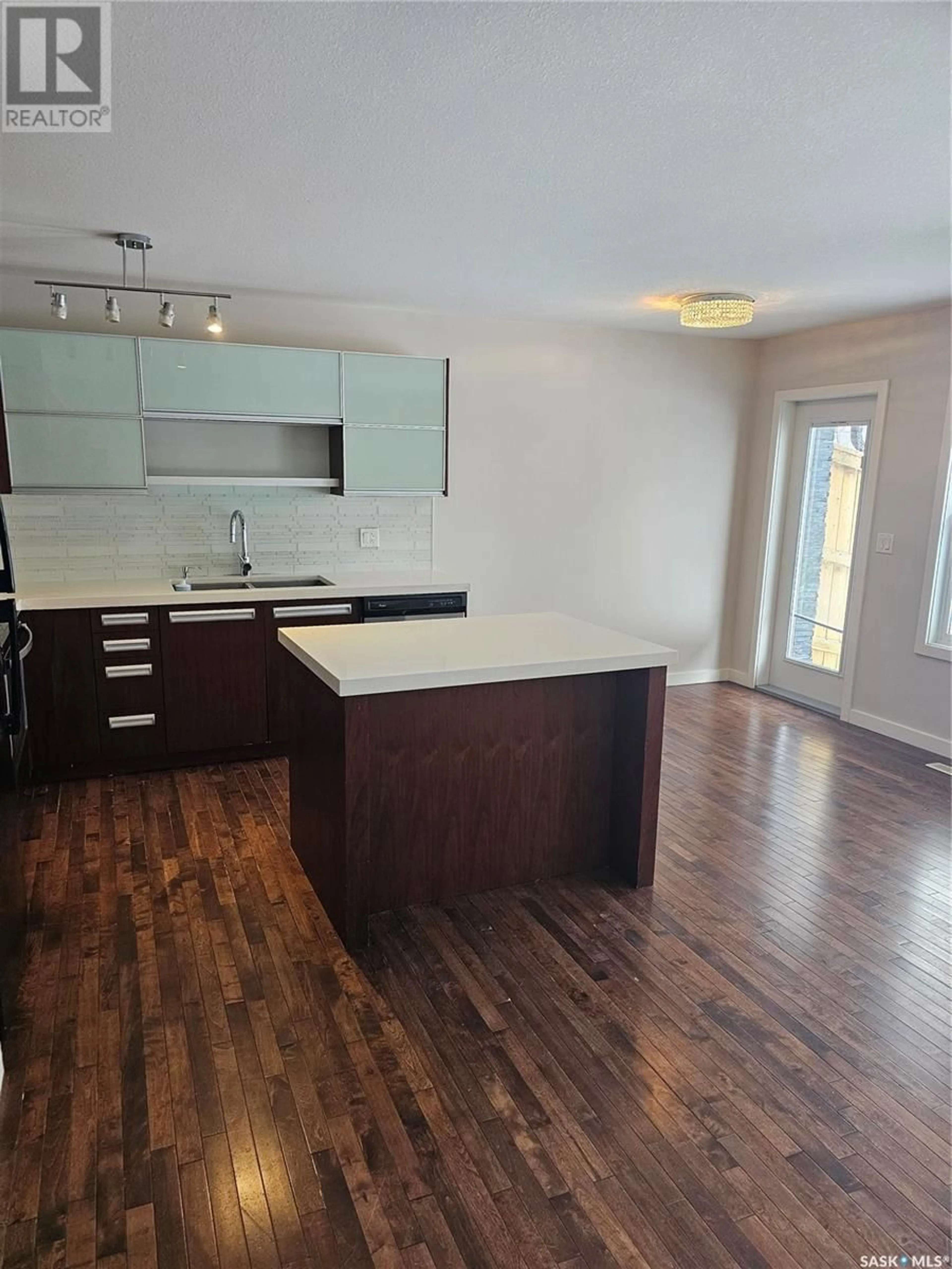 Open concept kitchen, wood/laminate floor for 408 1303 Paton CRESCENT, Saskatoon Saskatchewan S7W0B8