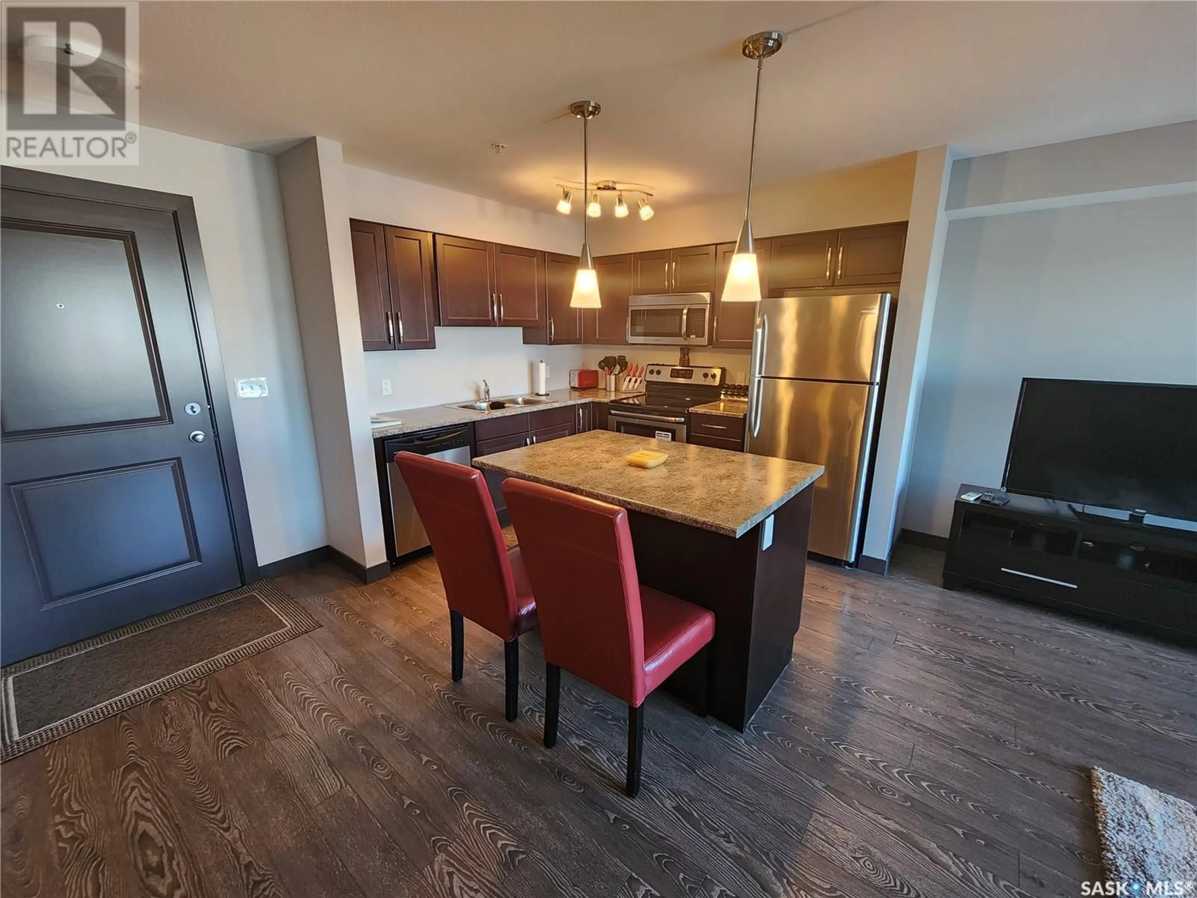 Open concept kitchen, wood/laminate floor for 307 2141 Larter ROAD, Estevan Saskatchewan S4A2Y5