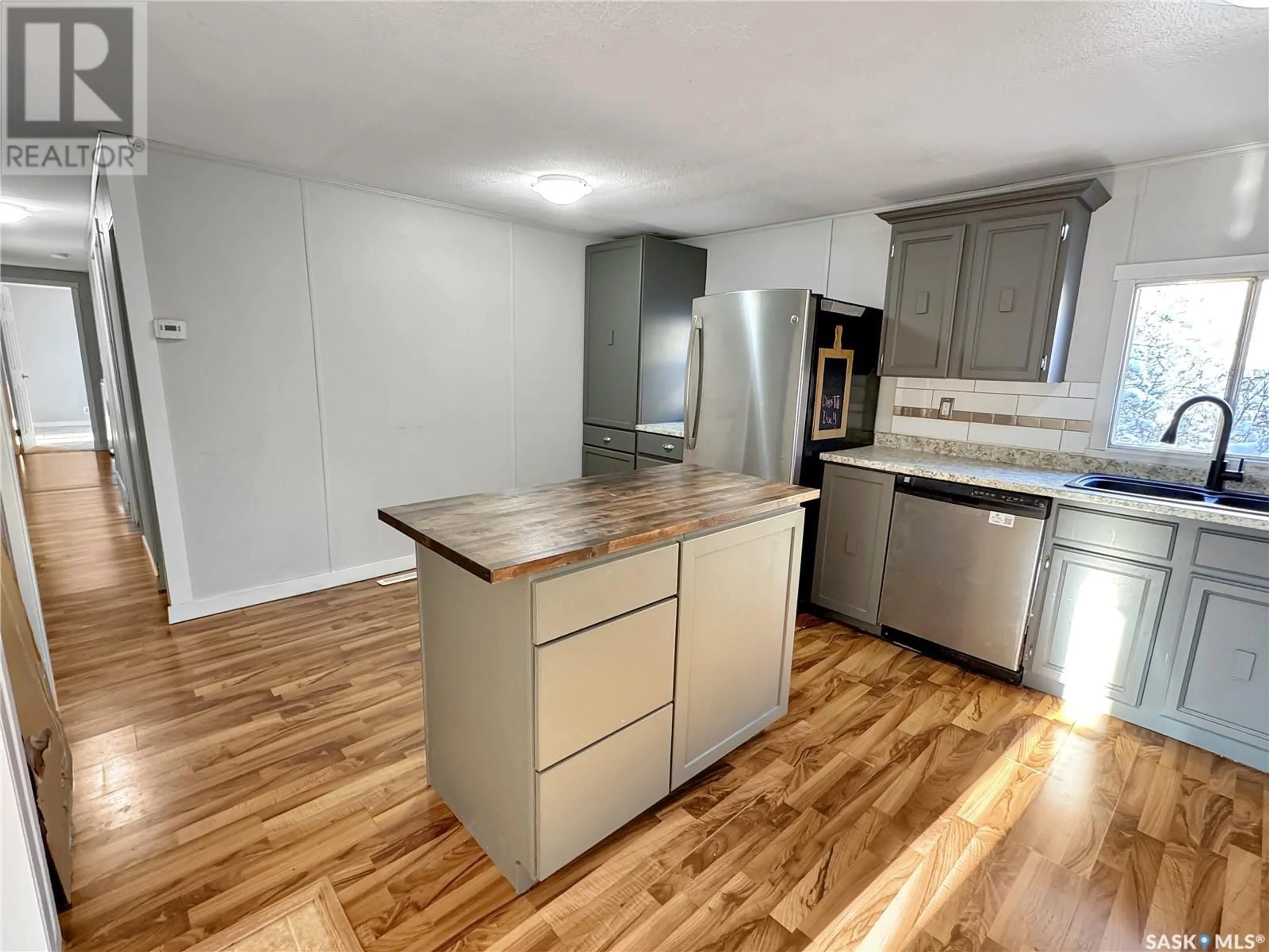 Open concept kitchen, wood/laminate floor for 212 3rd STREET W, Lashburn Saskatchewan S0M1H0