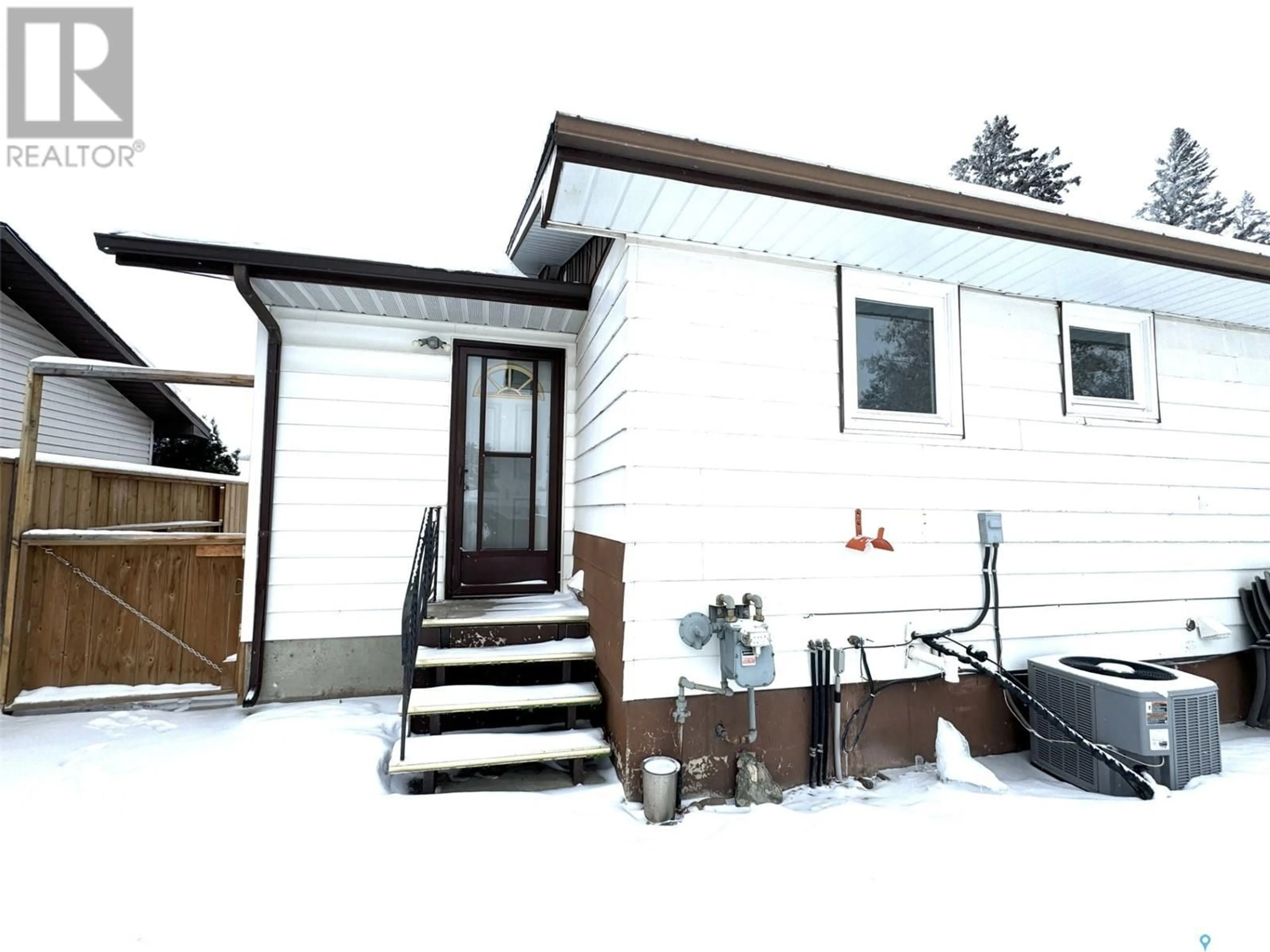 Home with vinyl exterior material, street for 404 7th AVENUE W, Biggar Saskatchewan S0K0M0