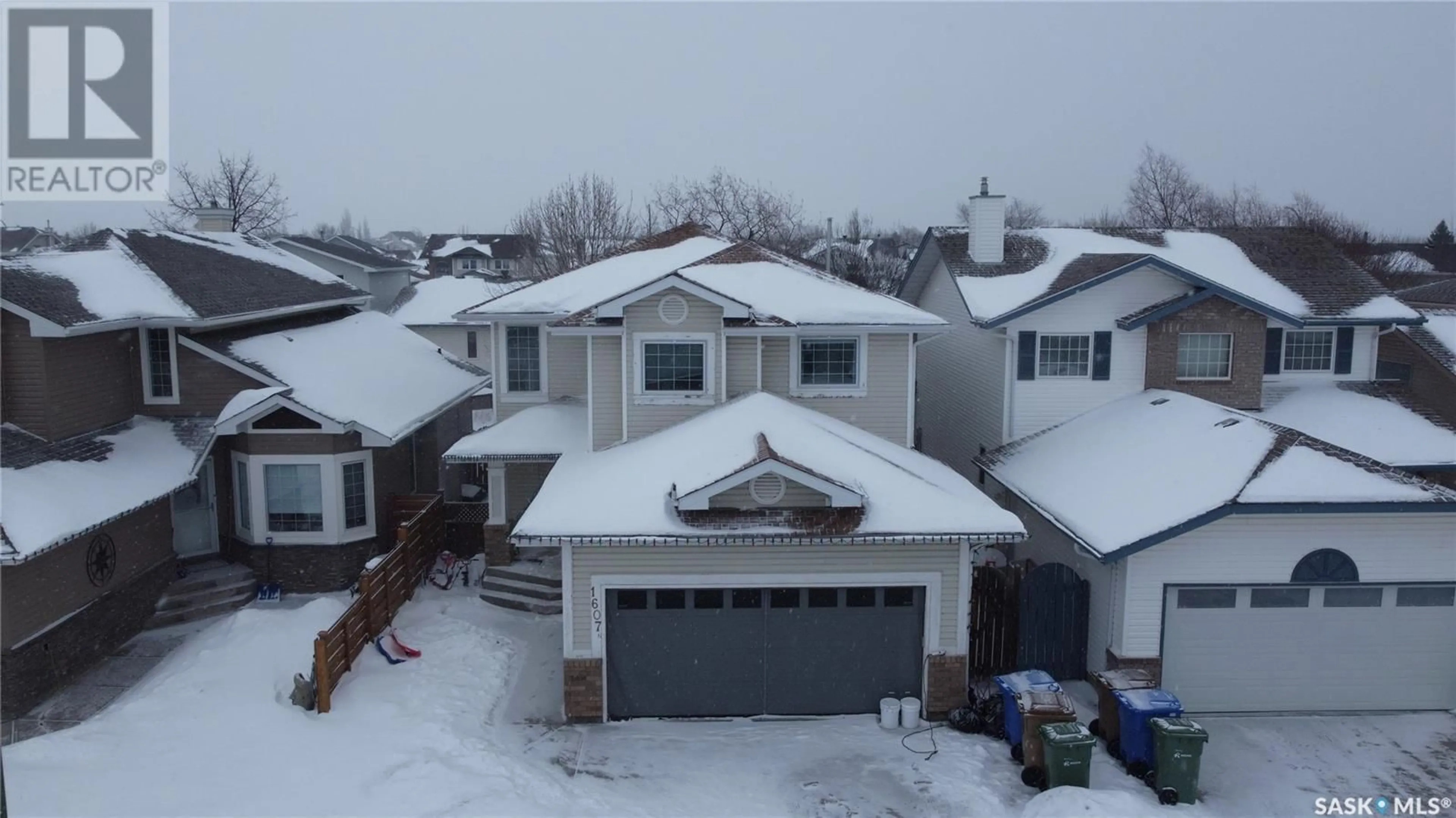 A pic from outside/outdoor area/front of a property/back of a property/a pic from drone, street for 1607 ROUSSEAU CRESCENT N, Regina Saskatchewan S4X4L8