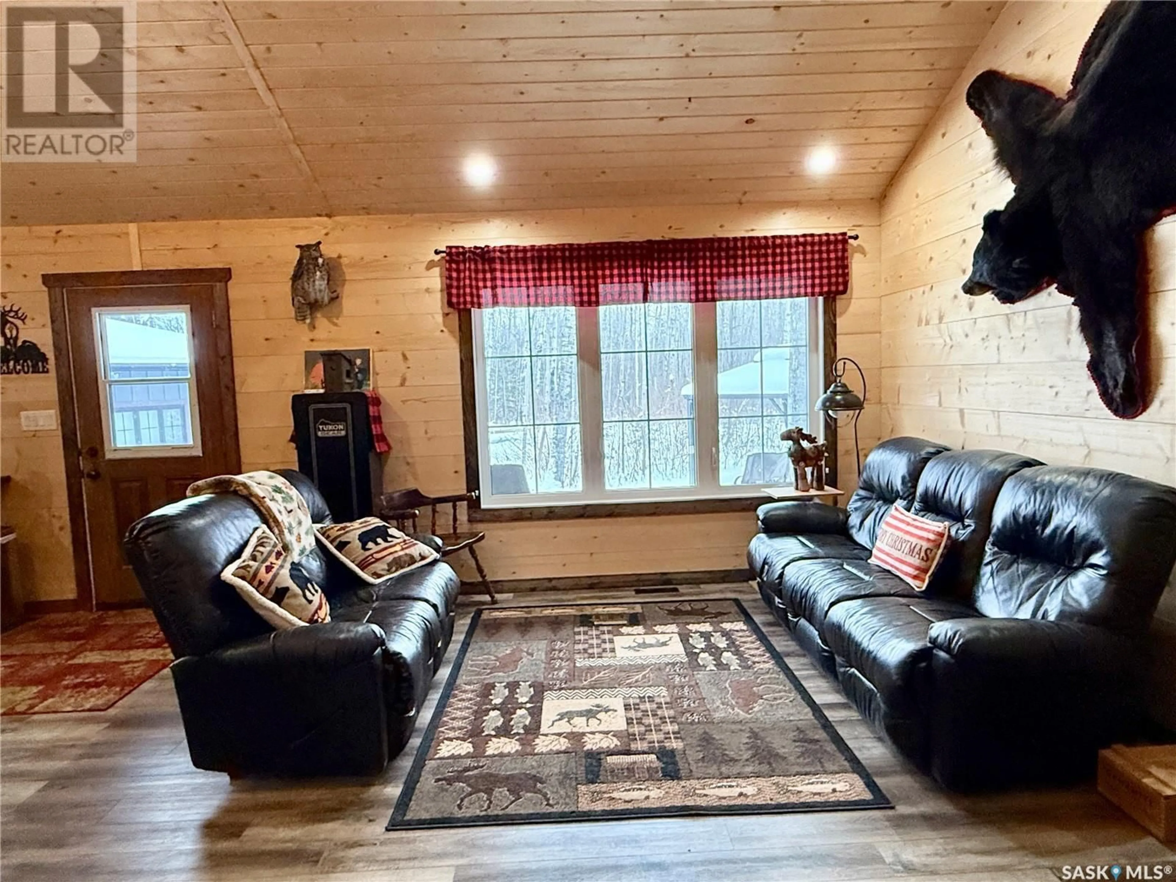 Living room with furniture, wood/laminate floor for 118 Phillips CRESCENT, Phillips Grove Saskatchewan S0J0E0