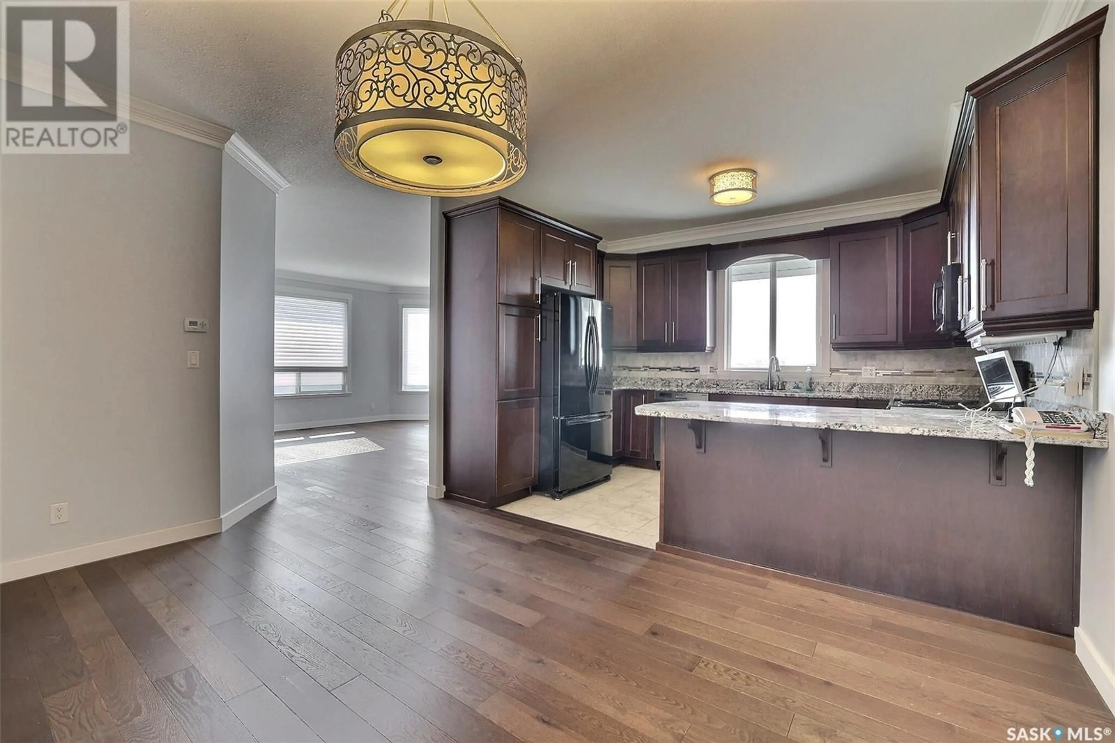 Open concept kitchen, wood/laminate floor for 305 3750 Haughton ROAD E, Regina Saskatchewan S4V1R6