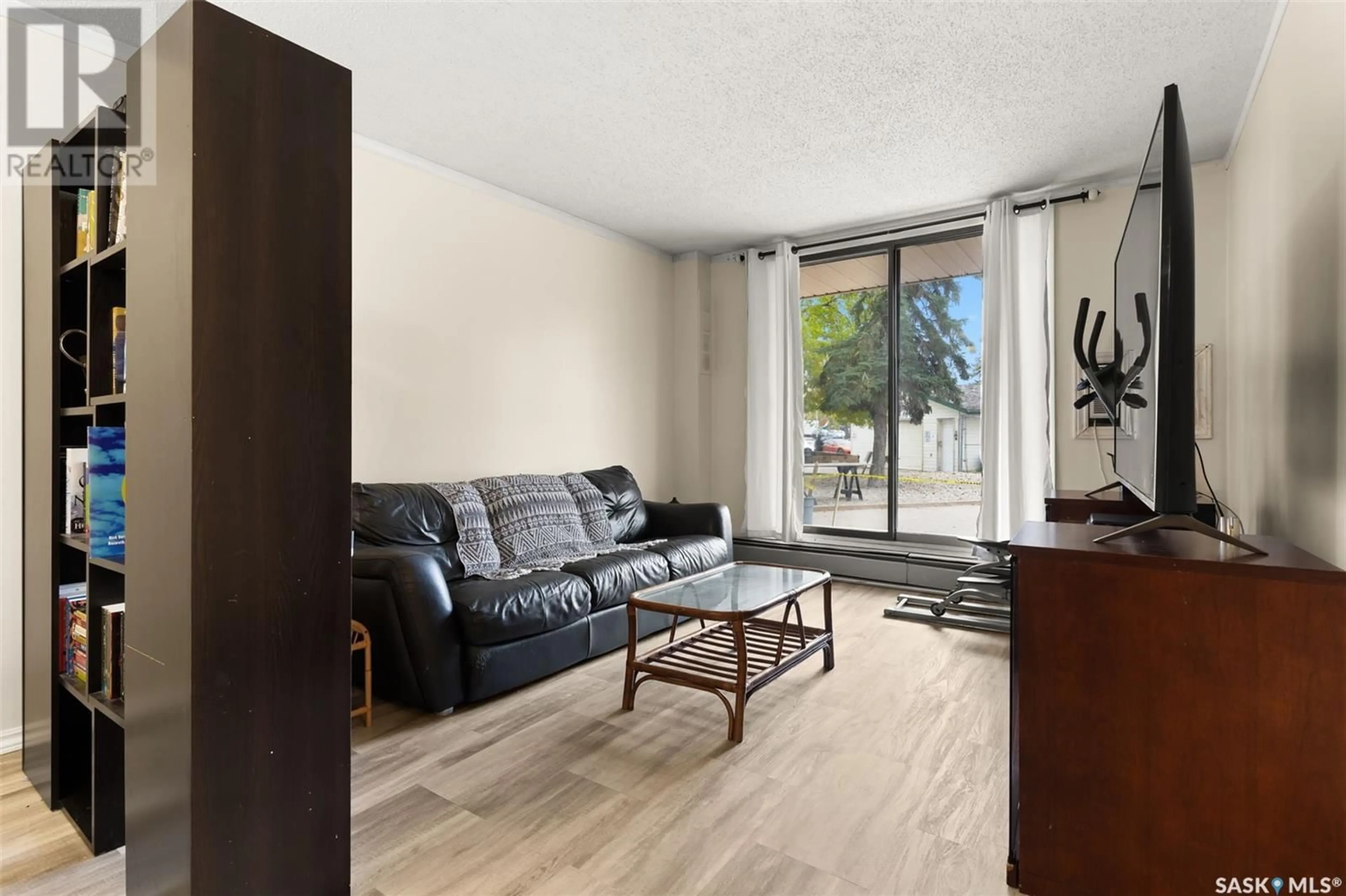 Living room with furniture, wood/laminate floor for 101 34 Nollet AVENUE, Regina Saskatchewan S4T7J8