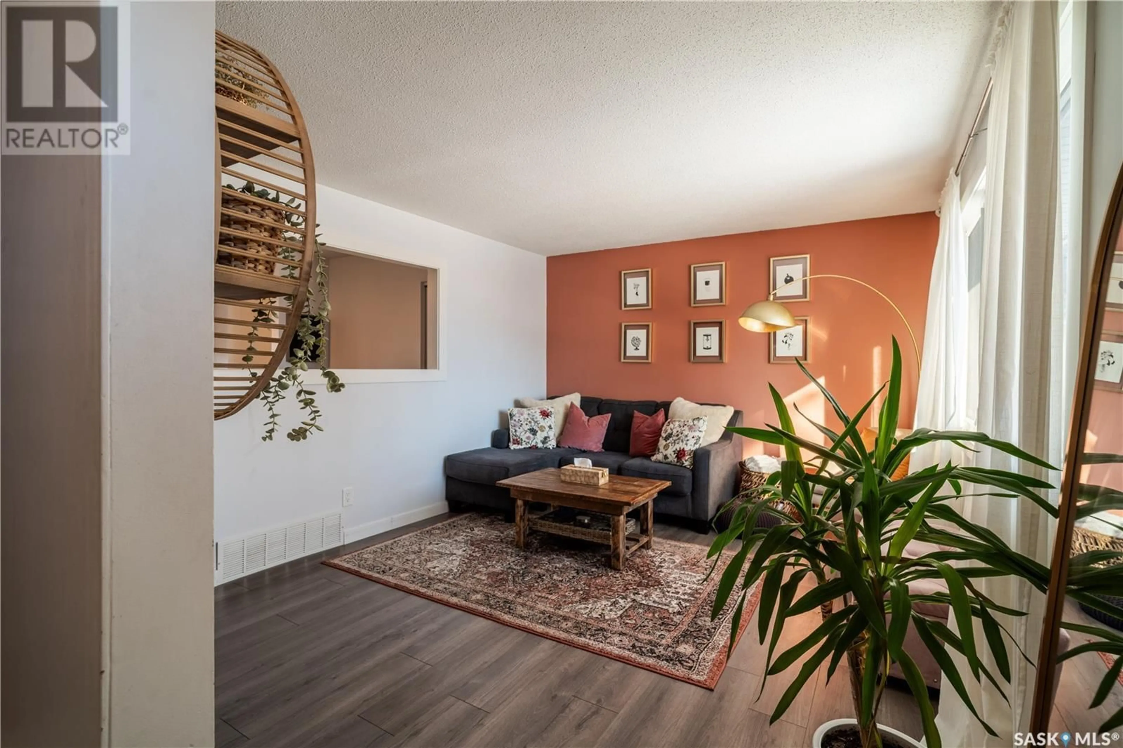 Living room with furniture, wood/laminate floor for 218 Forsyth CRESCENT, Regina Saskatchewan S4R5L5