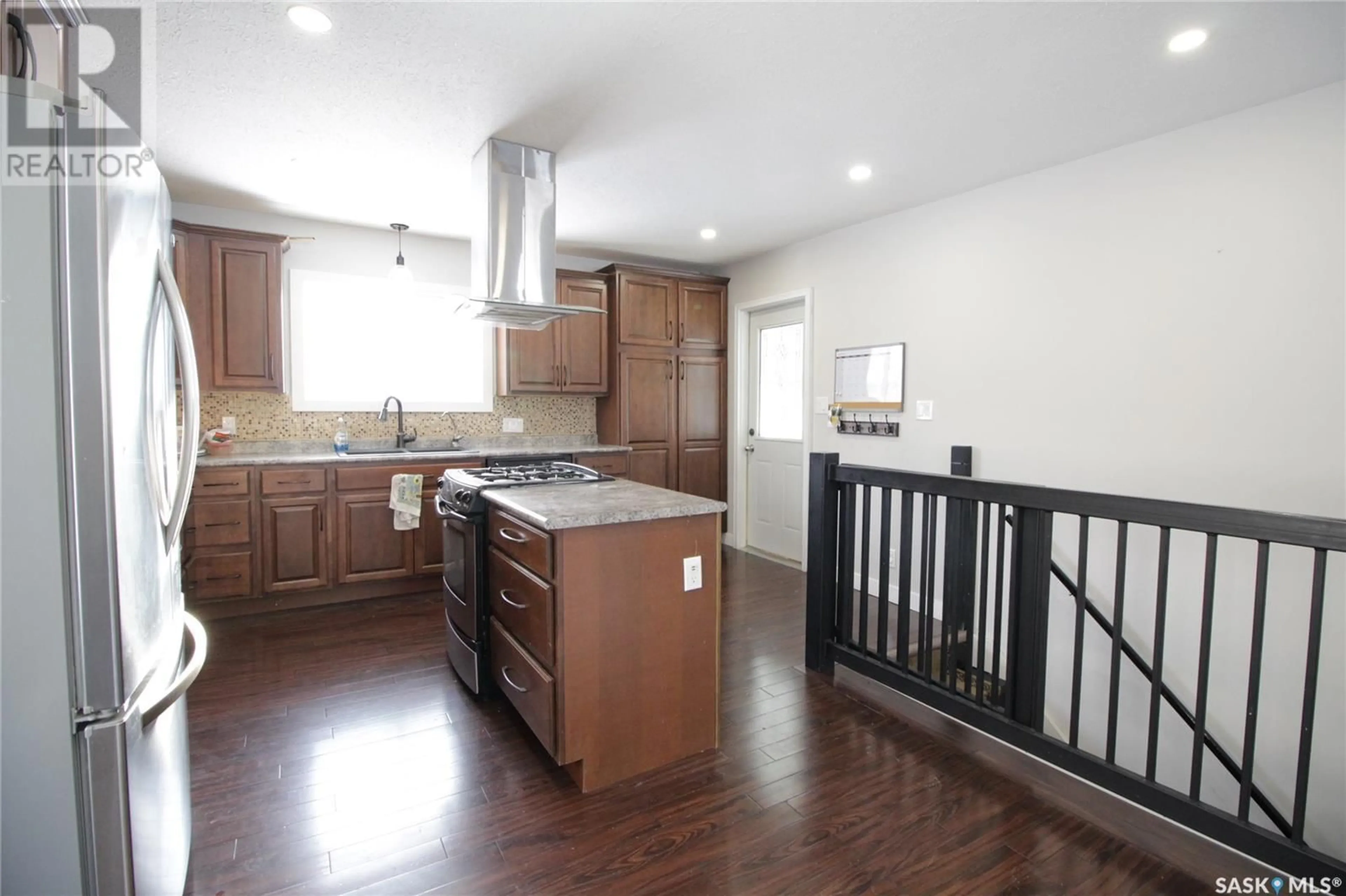 Open concept kitchen, wood/laminate floor for 1007 Carleton STREET, Moosomin Saskatchewan S0G3N0