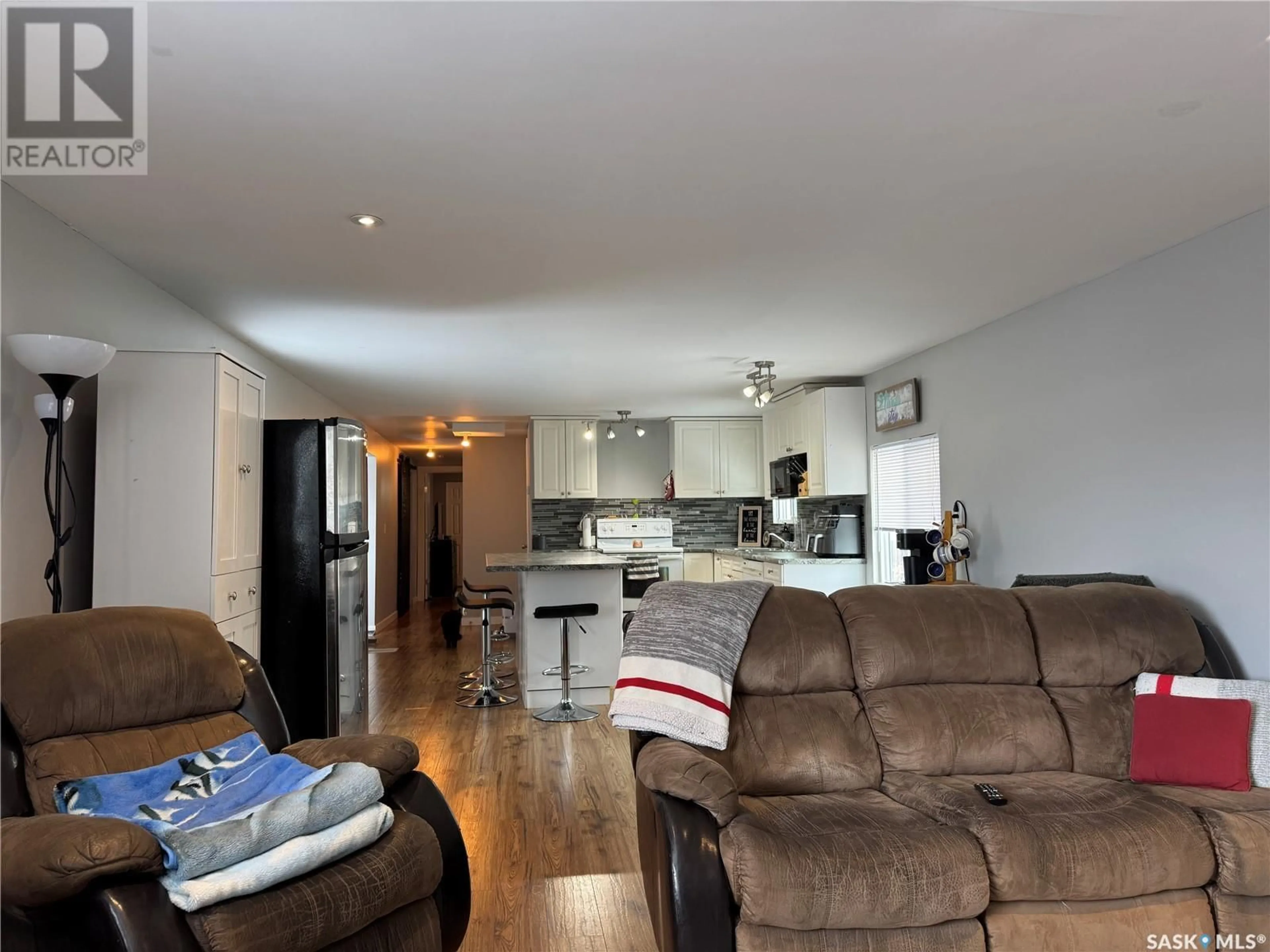 Living room with furniture, wood/laminate floor for 308 TESKY CRESCENT, Wynyard Saskatchewan S0A4T0