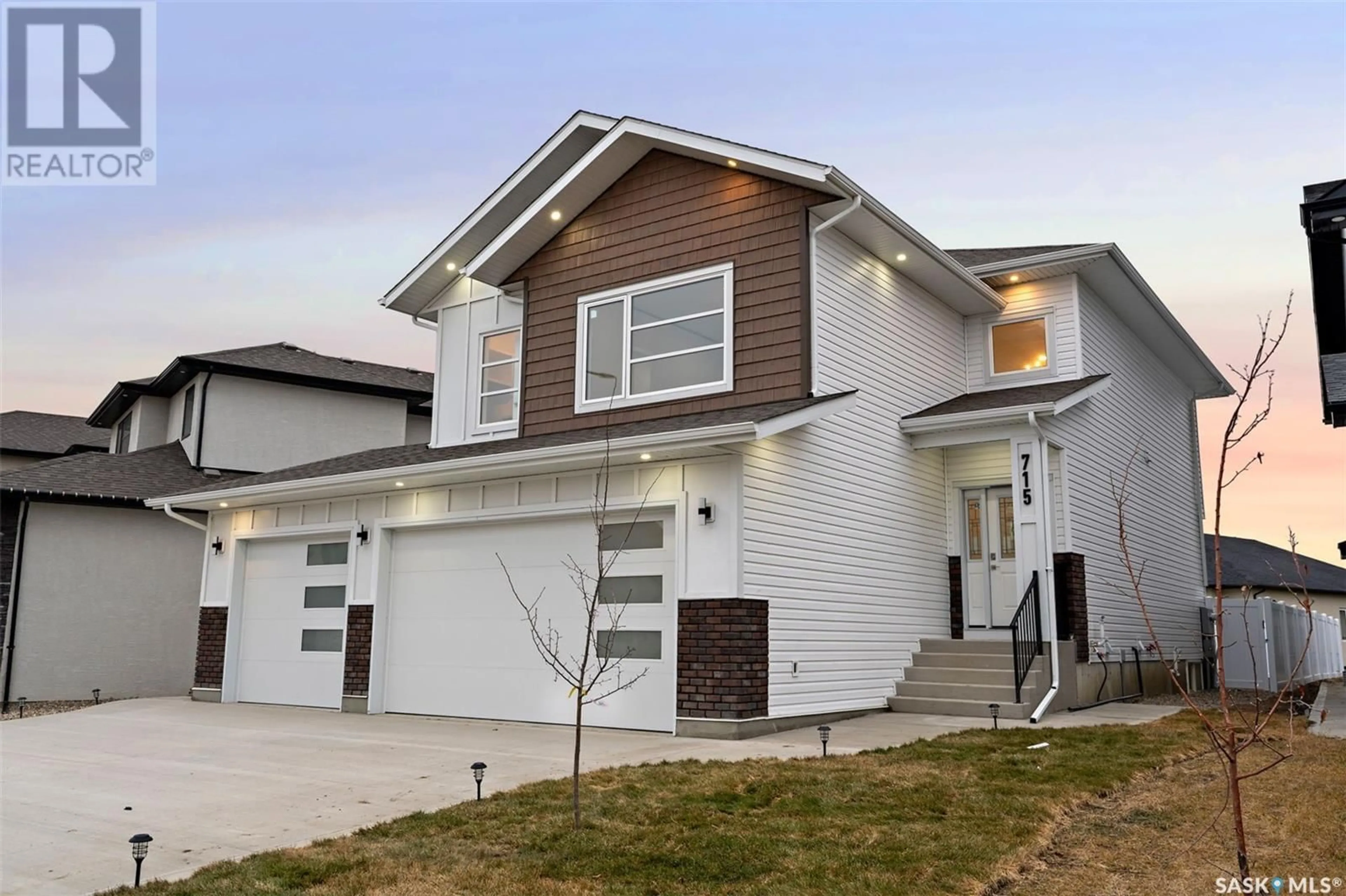 Home with vinyl exterior material, street for 715 Kenaschuk LINK, Saskatoon Saskatchewan S7W0Y4