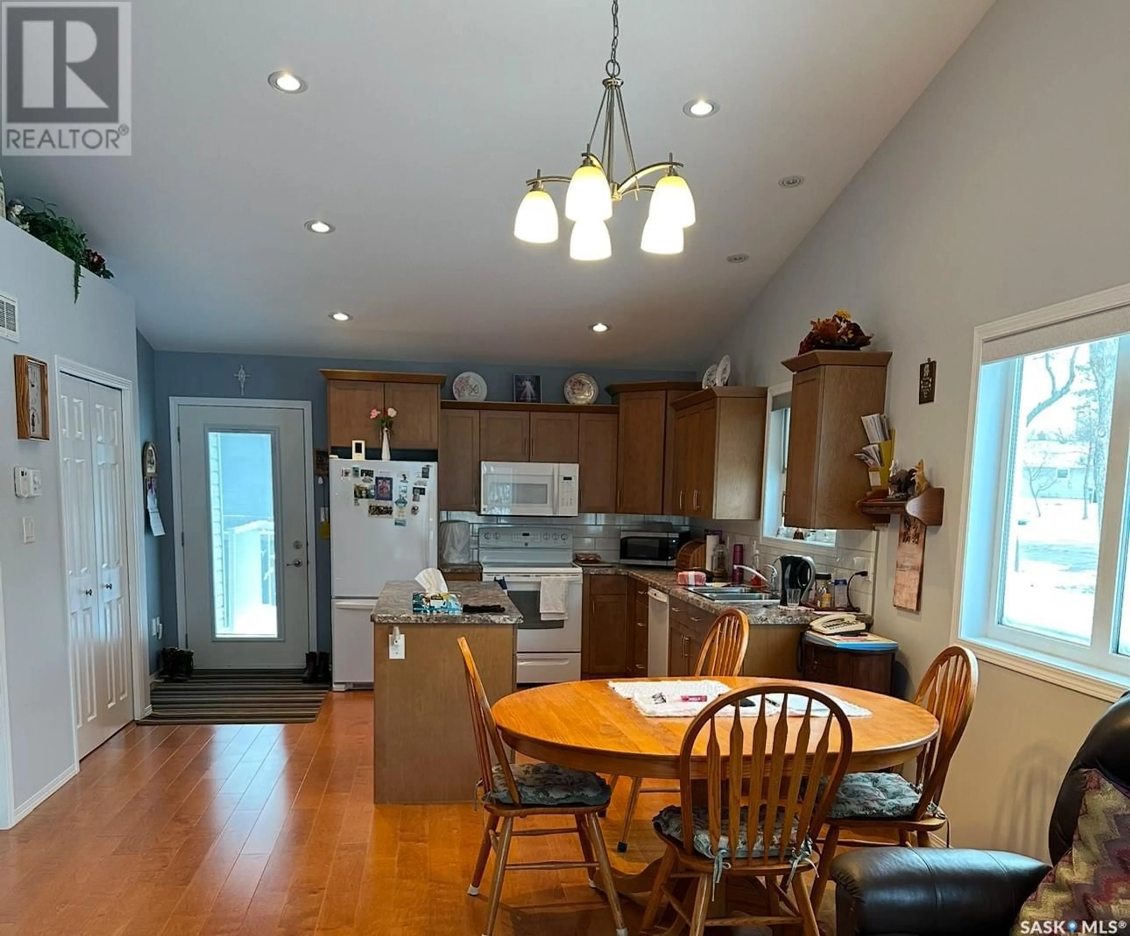 Open concept kitchen, wood/laminate floor for 3 401 3rd AVENUE E, Assiniboia Saskatchewan S0H0B0