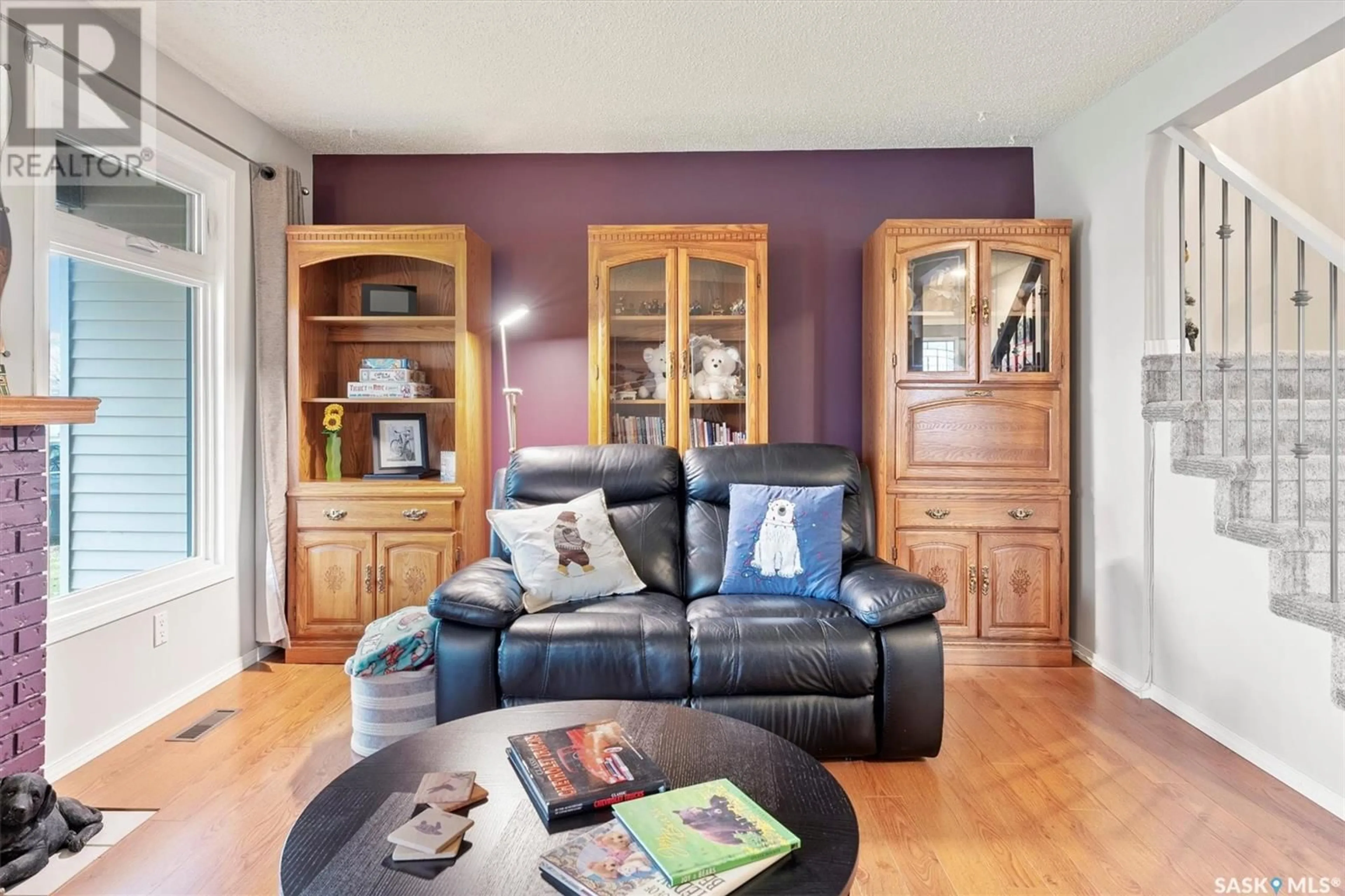 Living room with furniture, wood/laminate floor for 215 La Ronge ROAD, Saskatoon Saskatchewan S7K5C5