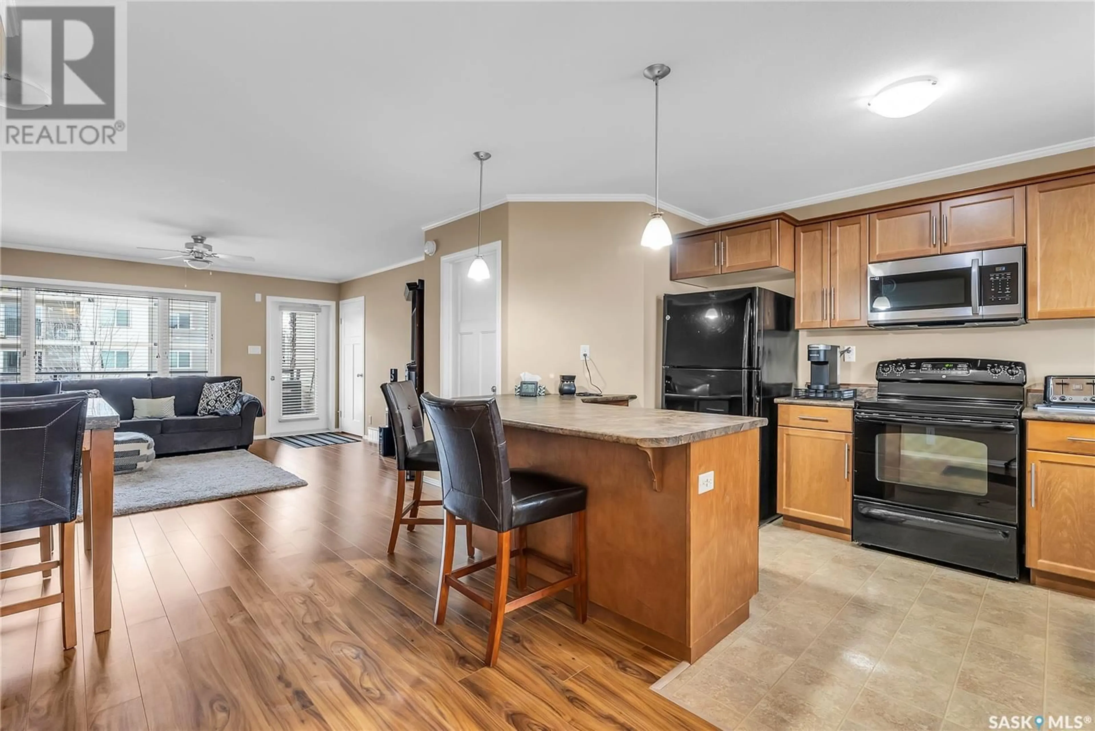 Open concept kitchen, wood/laminate floor for 306 110 Shillington CRESCENT, Saskatoon Saskatchewan S7M3Z8