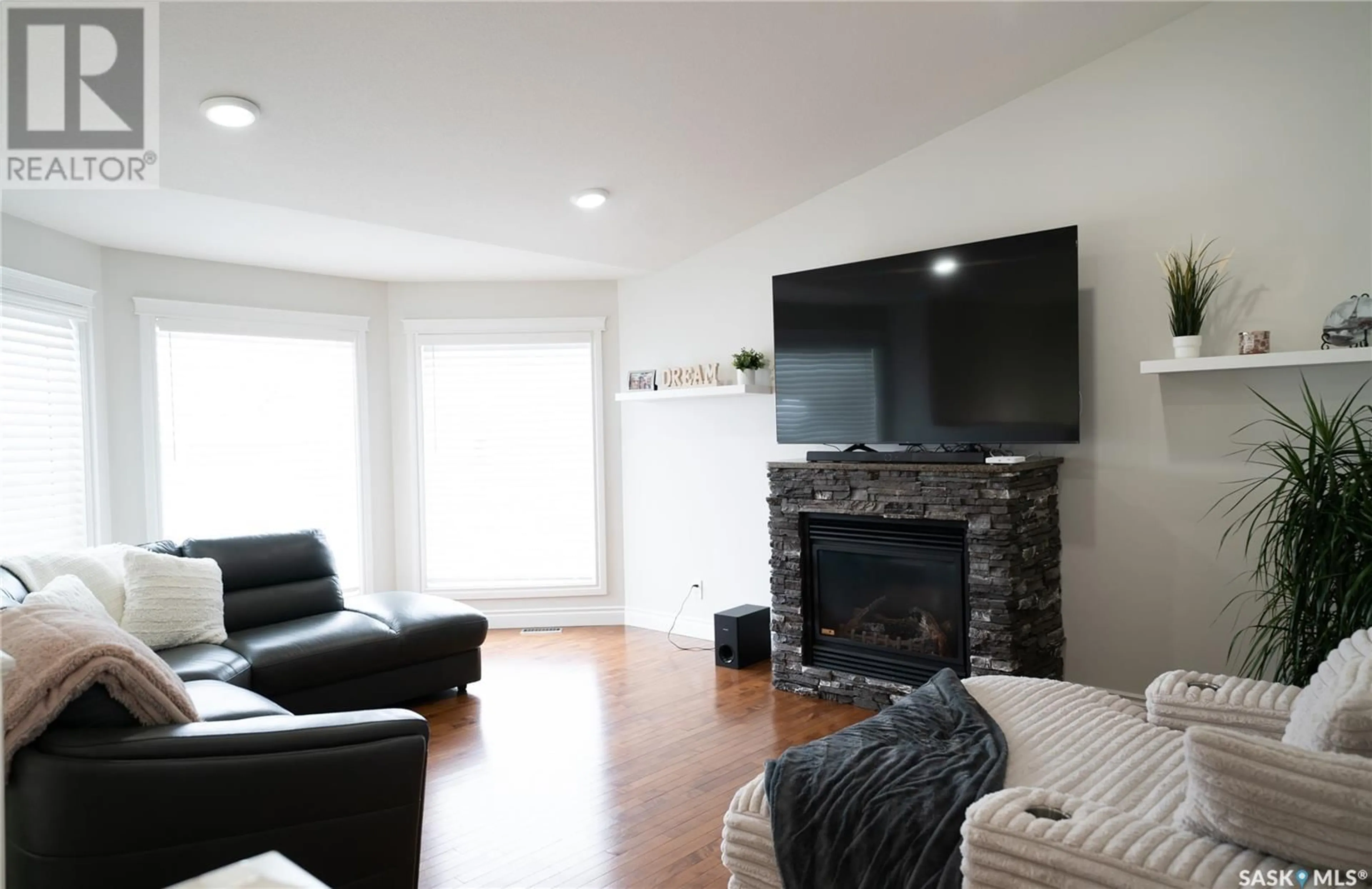 Living room with furniture, wood/laminate floor for 515 Antler CRESCENT, Warman Saskatchewan S0K4S1