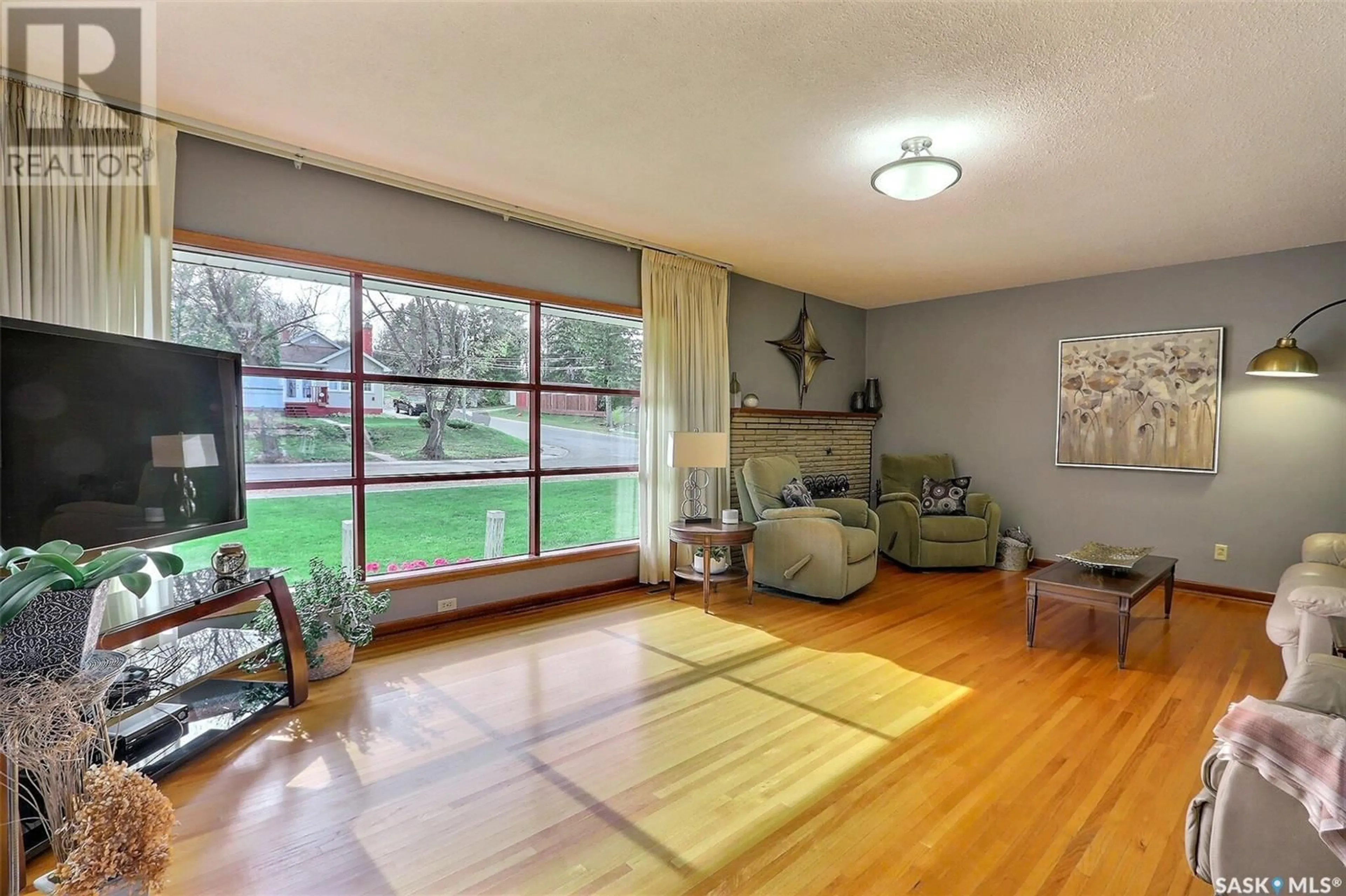 Living room with furniture, wood/laminate floor for 380 19TH STREET, Prince Albert Saskatchewan S6V4C7