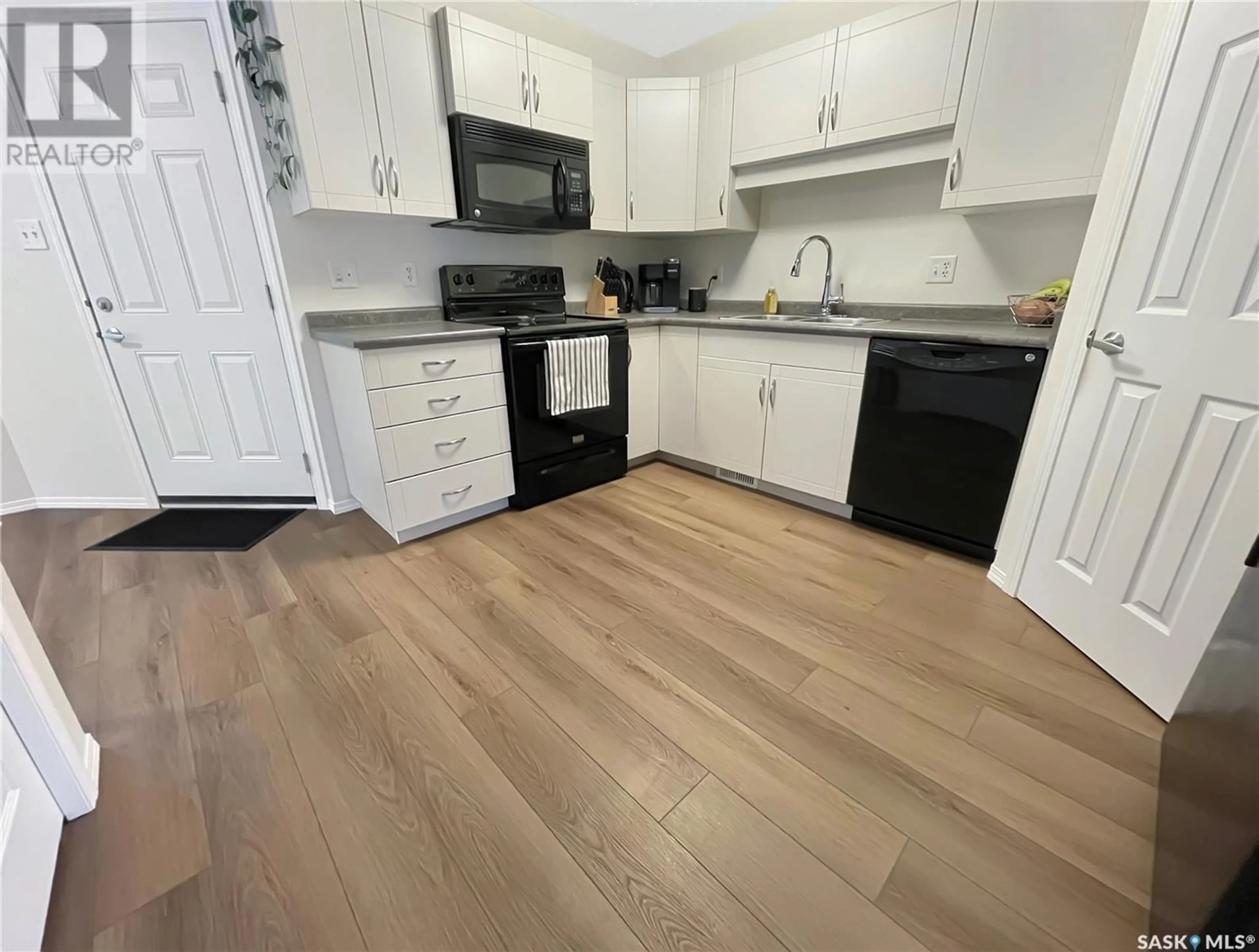 Open concept kitchen, wood/laminate floor for #122 503 Colonel Otter DRIVE, Swift Current Saskatchewan S9H2K4