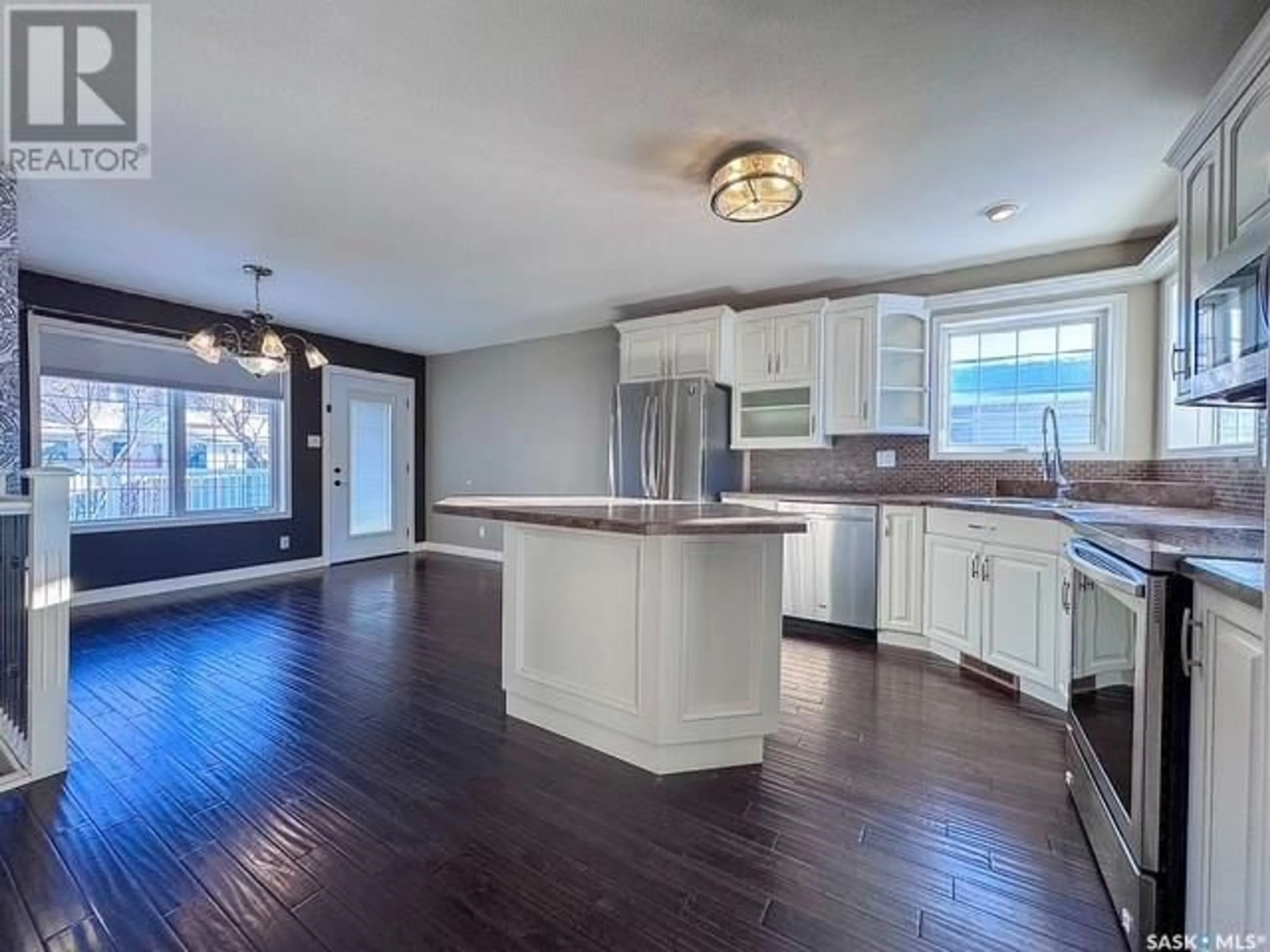 Open concept kitchen, wood/laminate floor for 511 Palliser DRIVE, Swift Current Saskatchewan S9H5C5