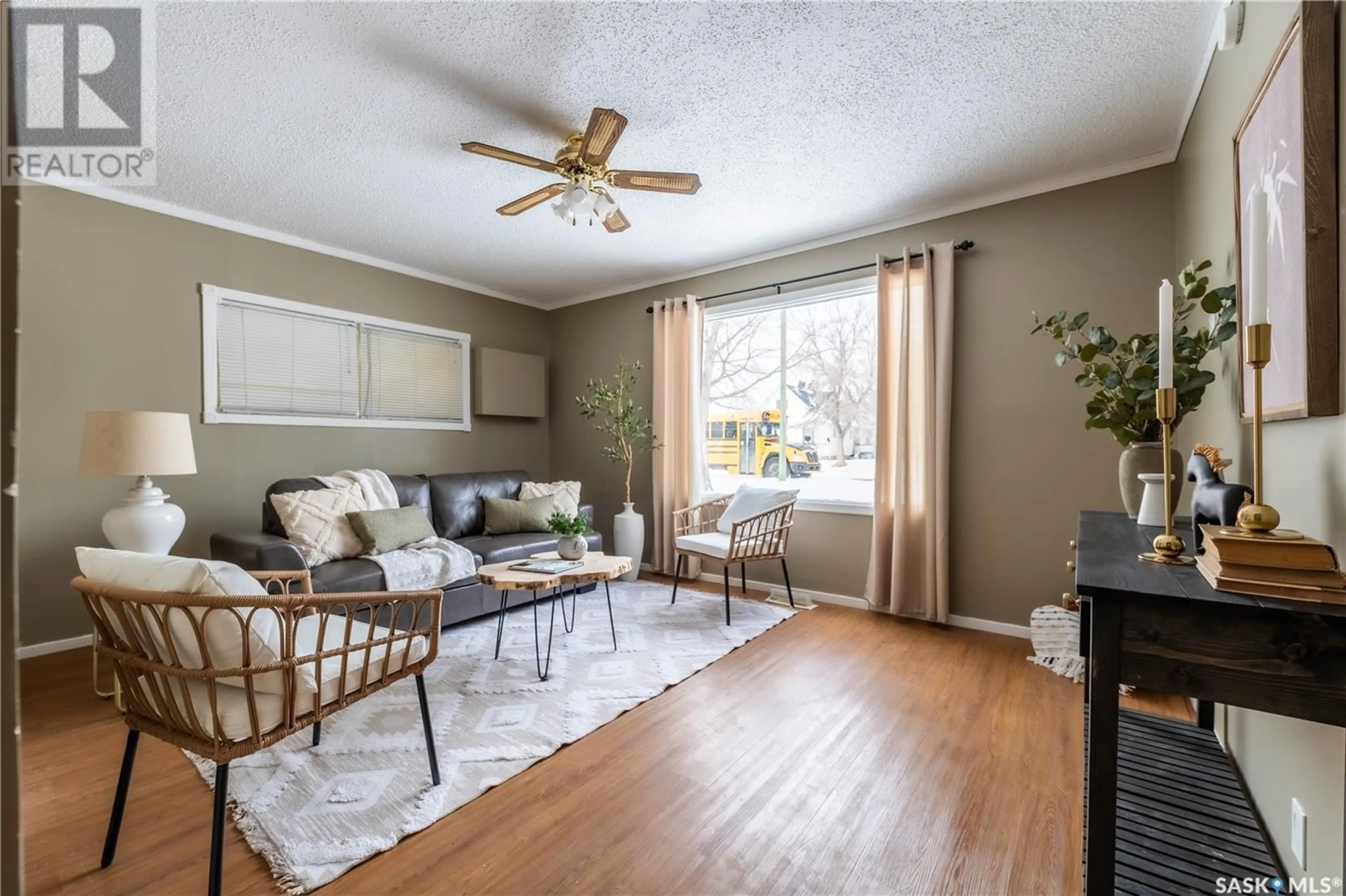 Living room with furniture, wood/laminate floor for 713 STADACONA STREET E, Moose Jaw Saskatchewan S6H0K3