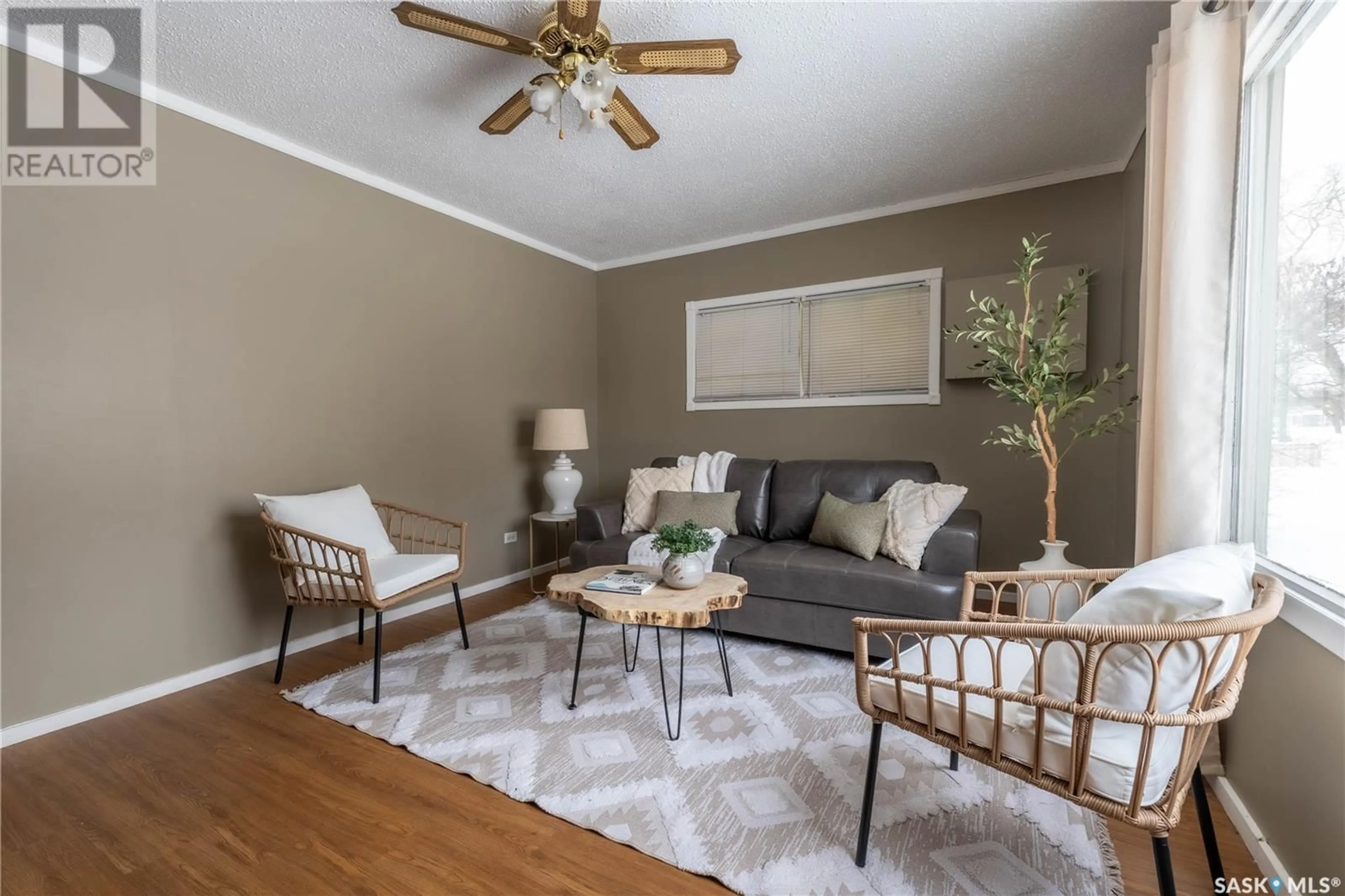 Living room with furniture, wood/laminate floor for 713 STADACONA STREET E, Moose Jaw Saskatchewan S6H0K3