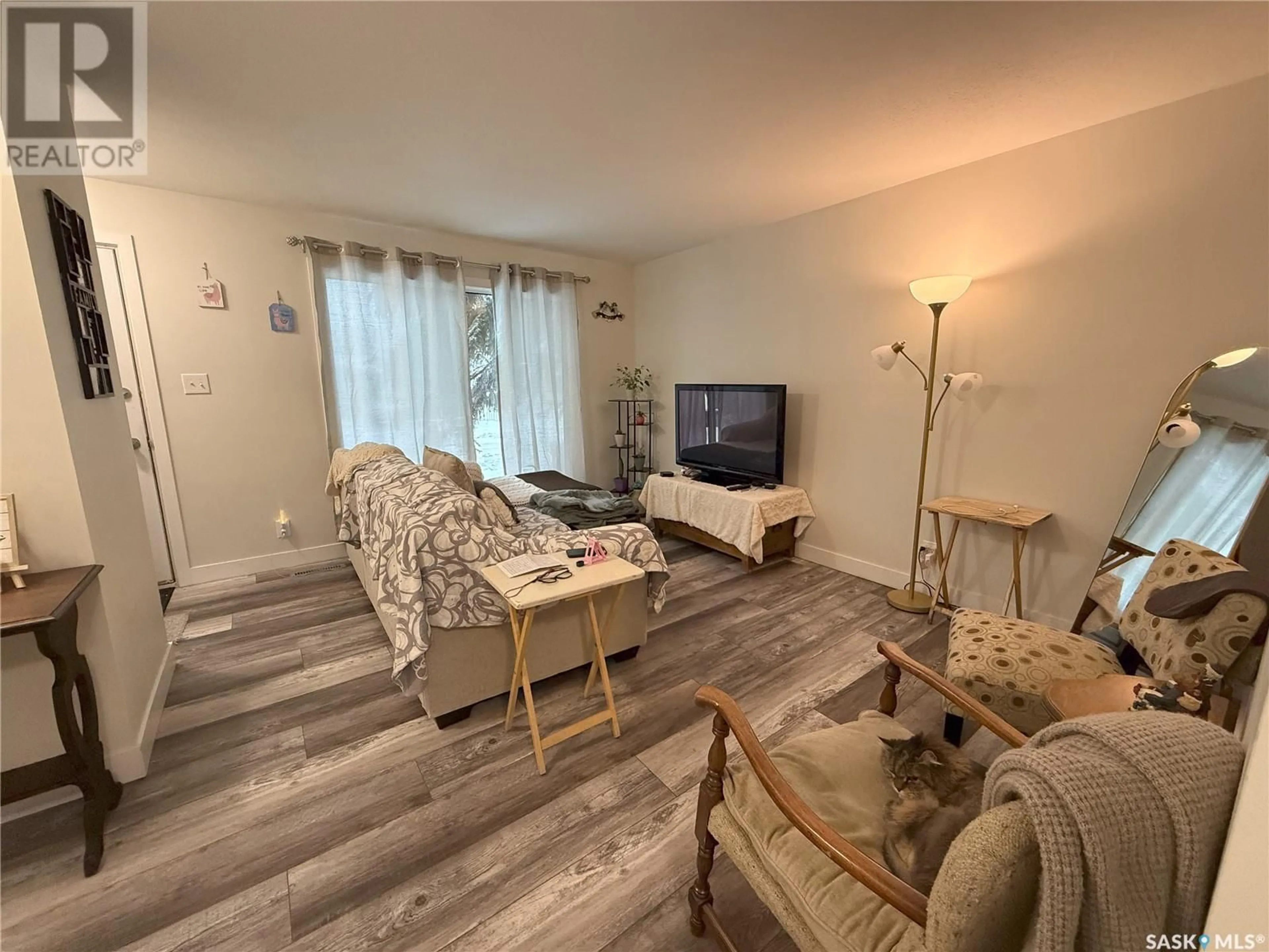 Living room with furniture, wood/laminate floor for 1372 - 1382 108TH STREET, North Battleford Saskatchewan S9A3J8