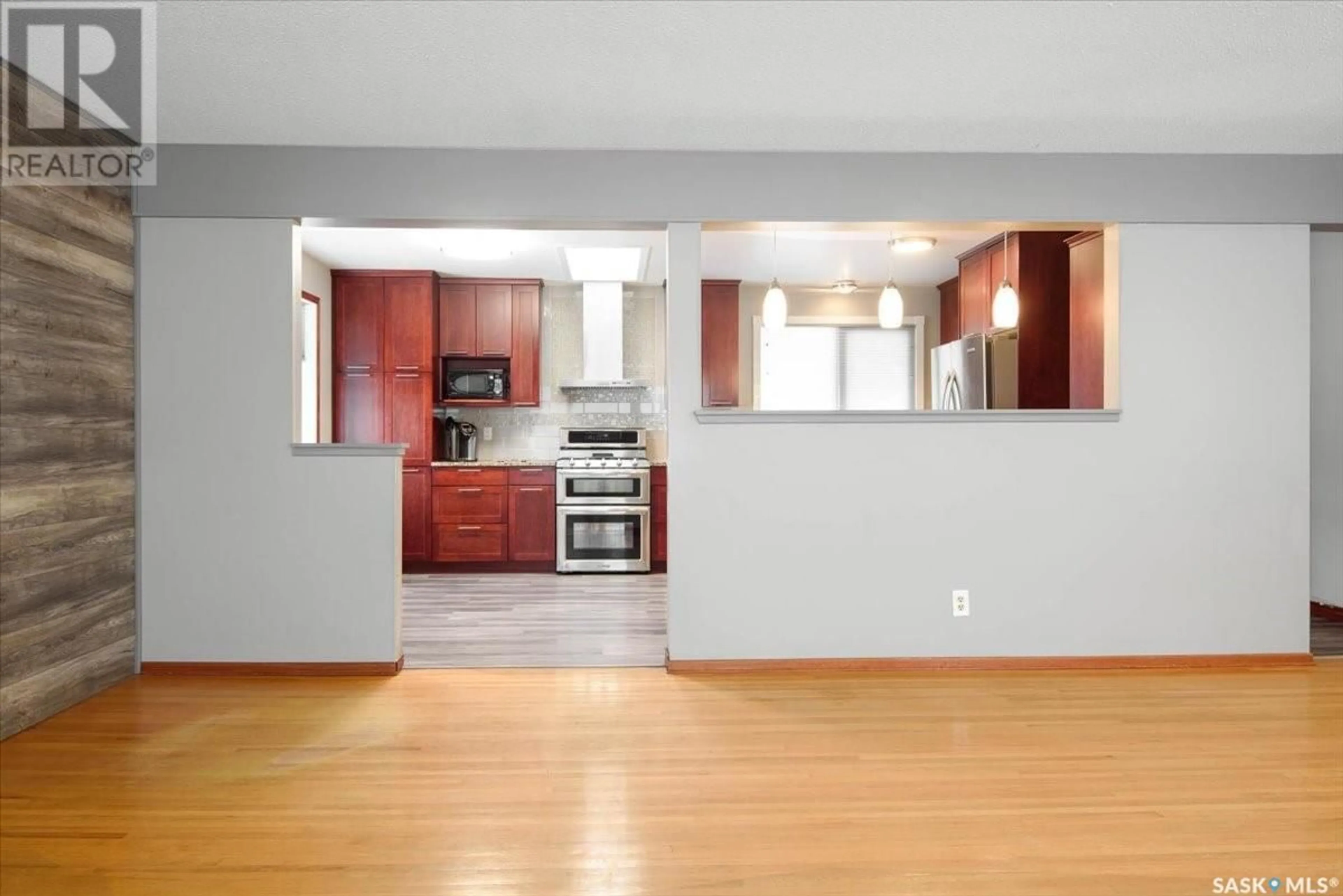 Open concept kitchen, wood/laminate floor for 38 MERLIN CRESCENT, Regina Saskatchewan S4R3E2